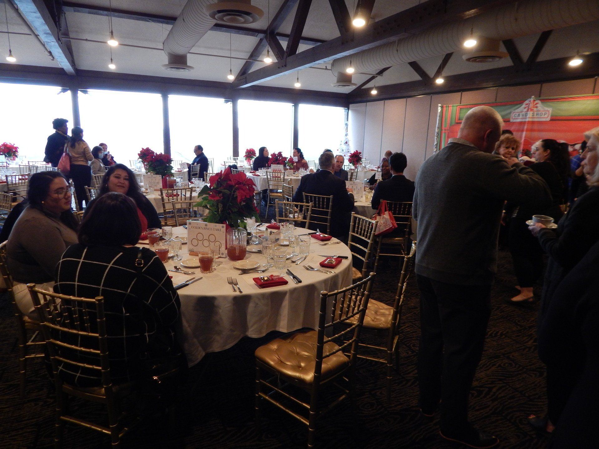 A group of people are sitting at tables in a large room
