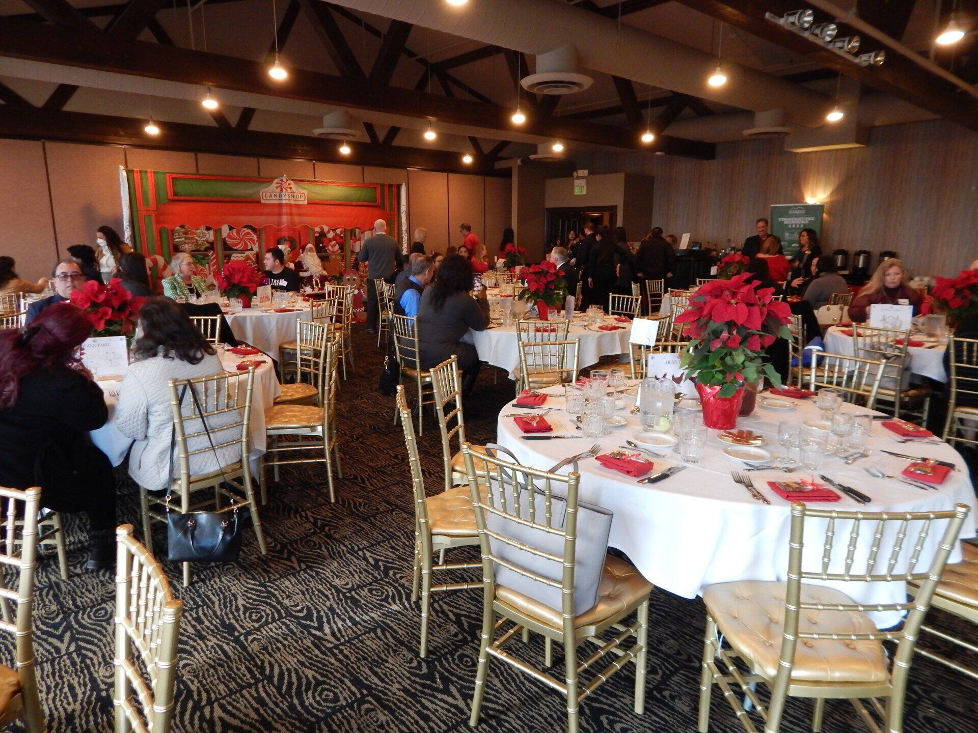 A large room with tables and chairs set up for a party
