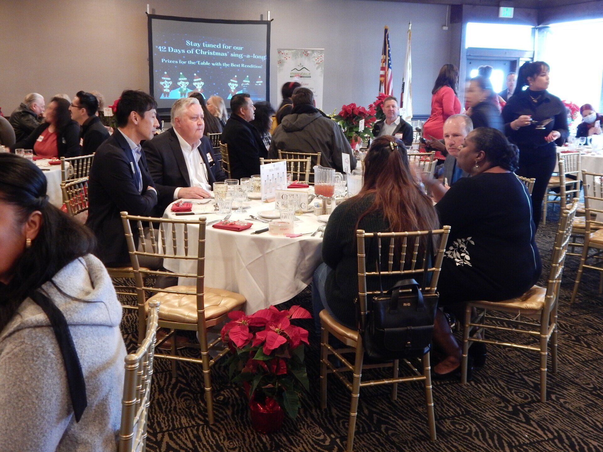 A group of people are sitting at tables in a room