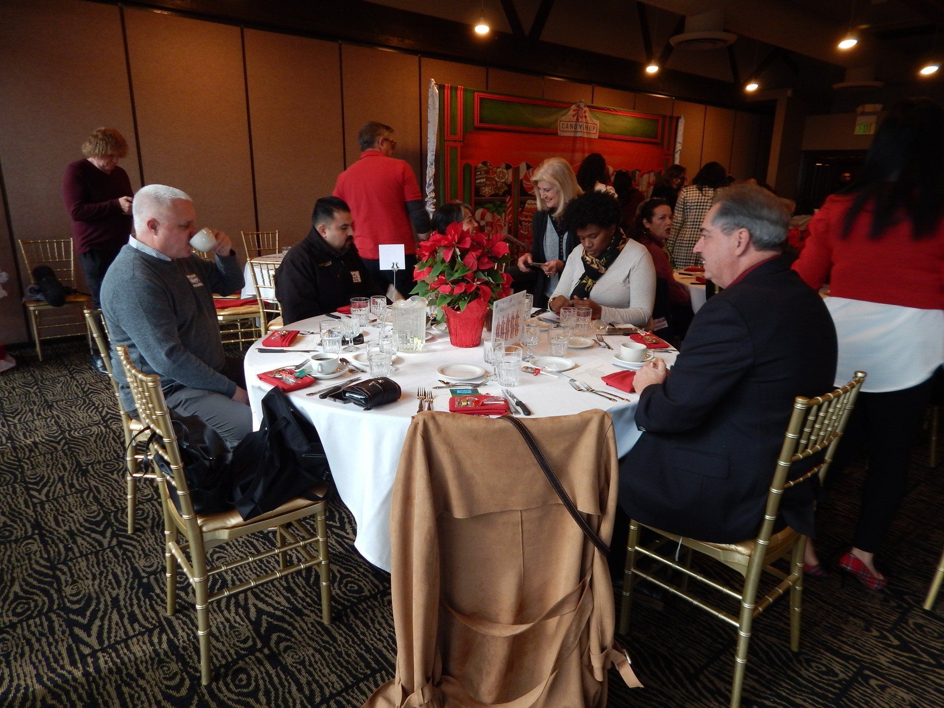 A group of people are sitting around a table in a room.