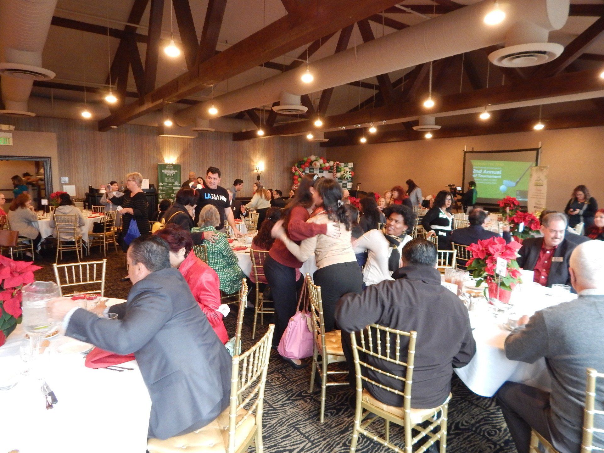 A group of people are sitting at tables in a large room.