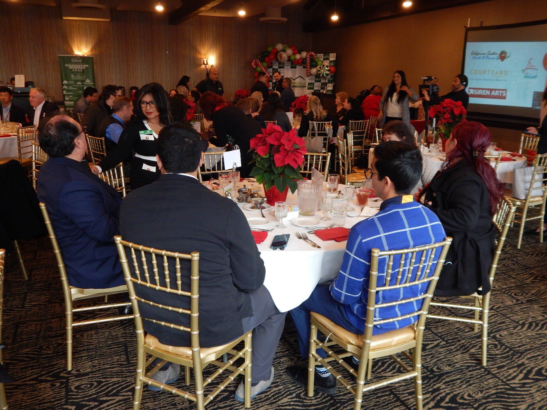 A group of people are sitting at tables in a room