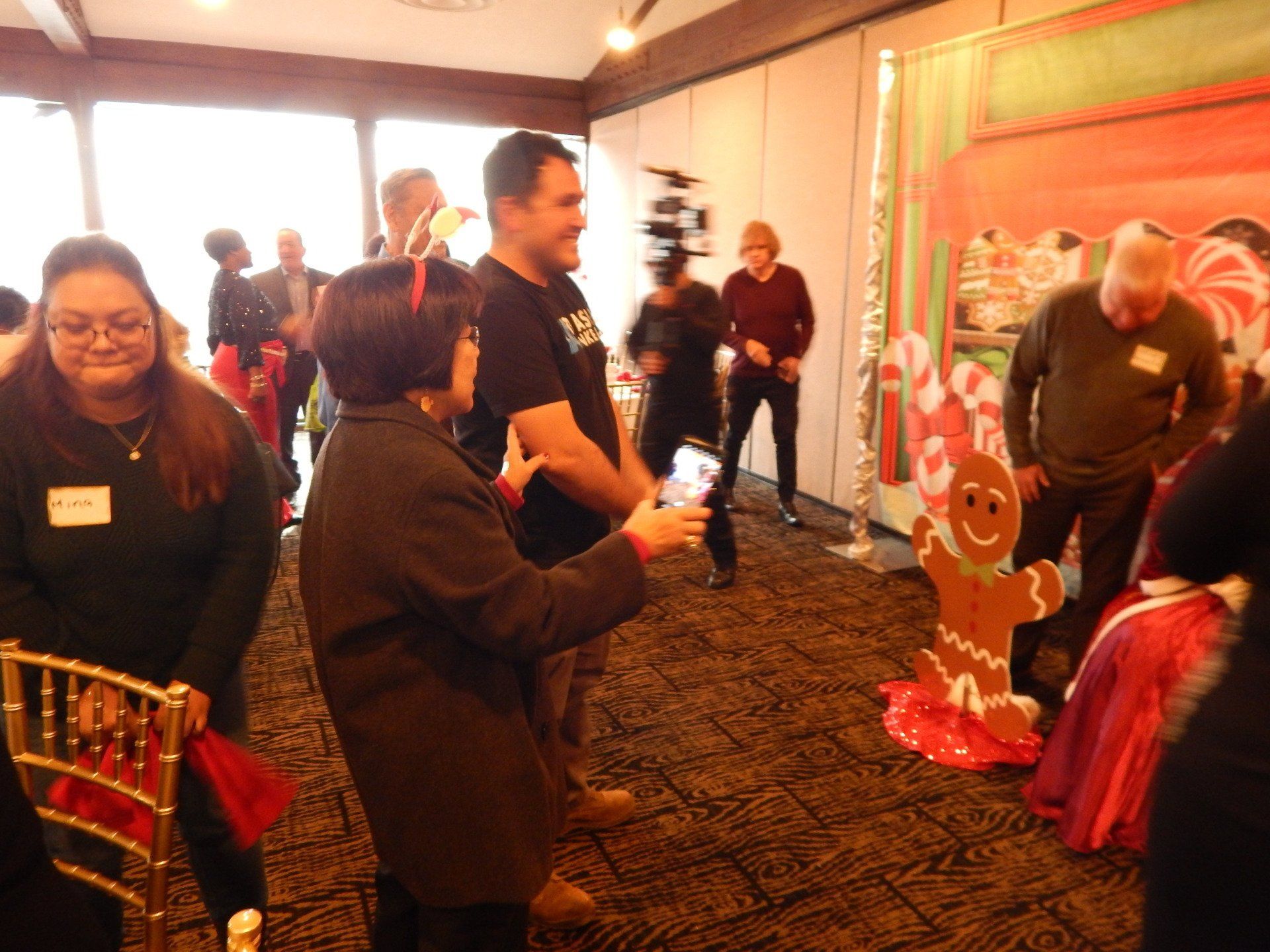A group of people standing around a gingerbread man