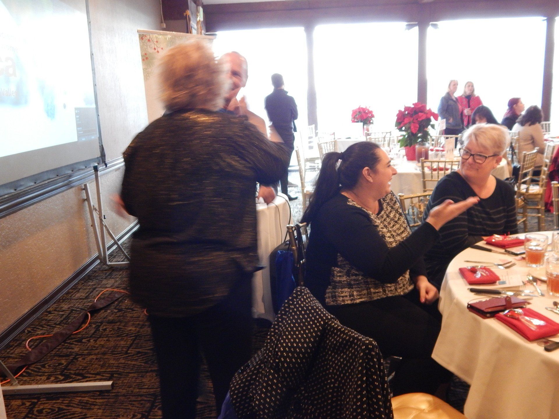 A group of people are sitting at tables in a room