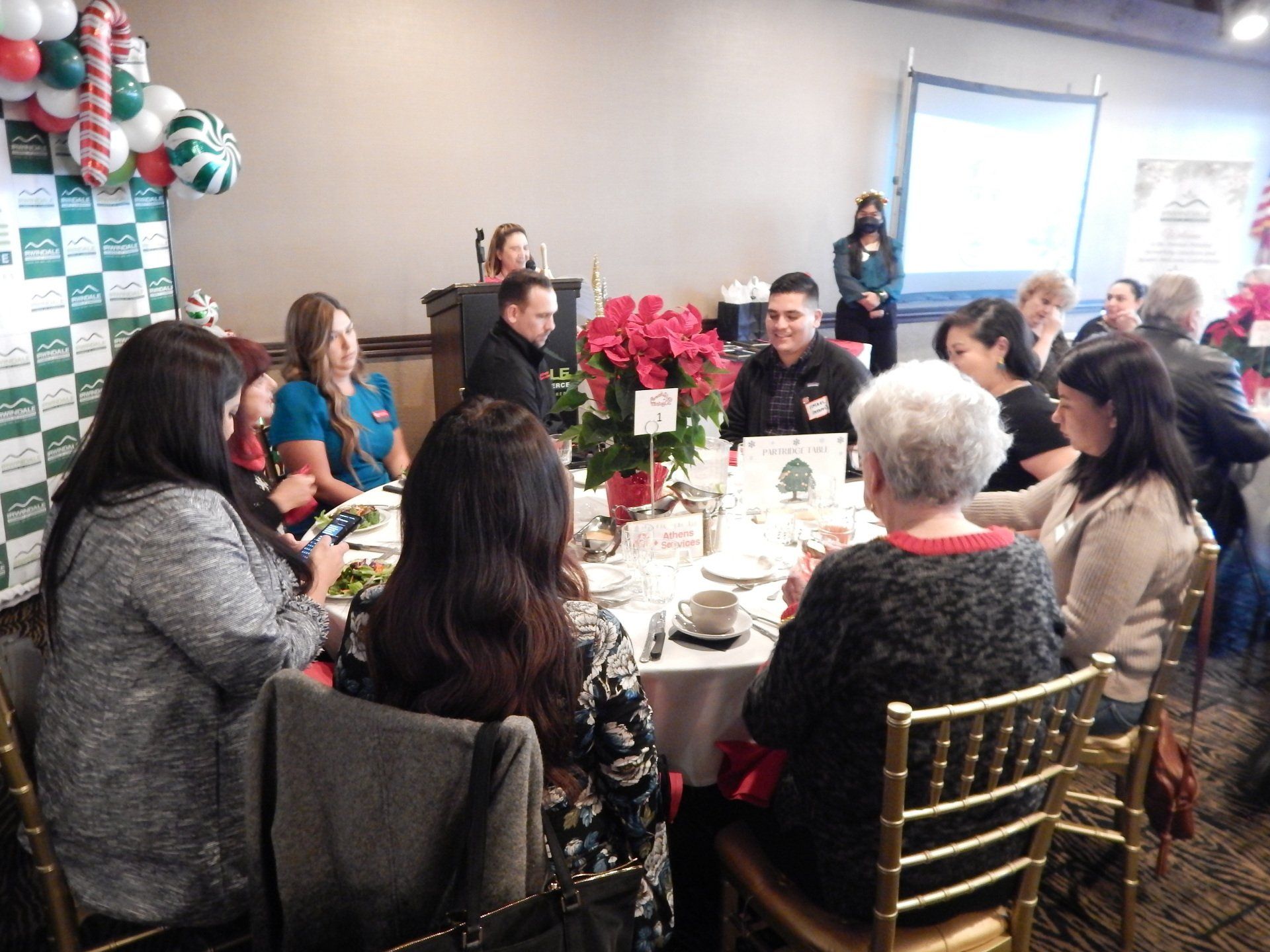 A group of people are sitting around a table in a room.