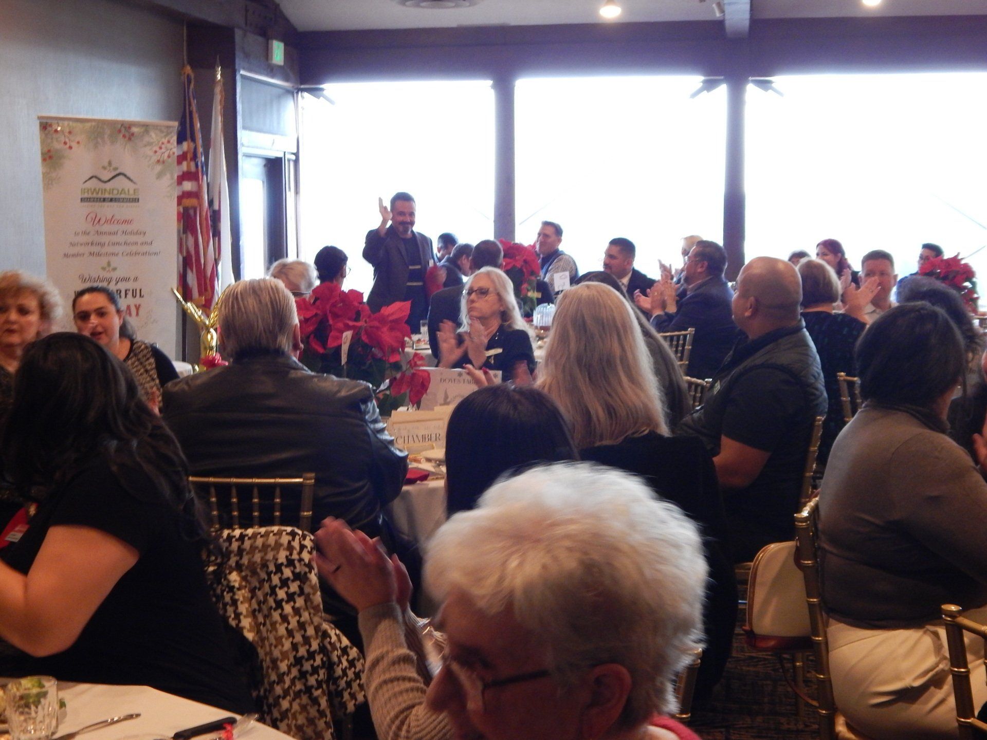 A large group of people are sitting at tables in a room