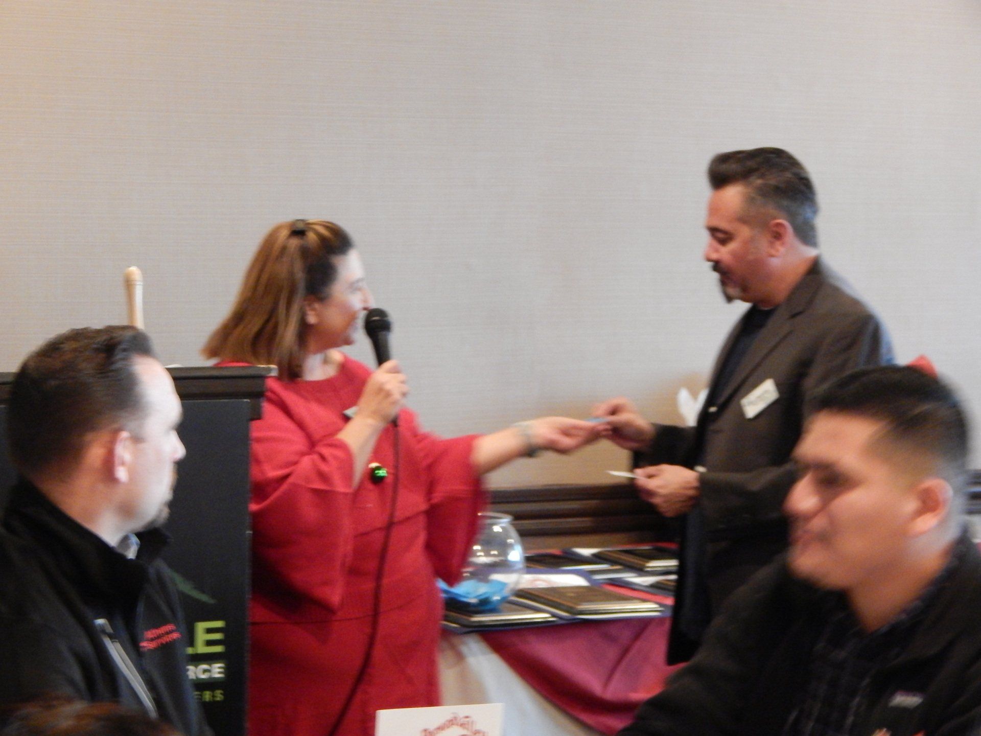 A woman speaking into a microphone at a conference