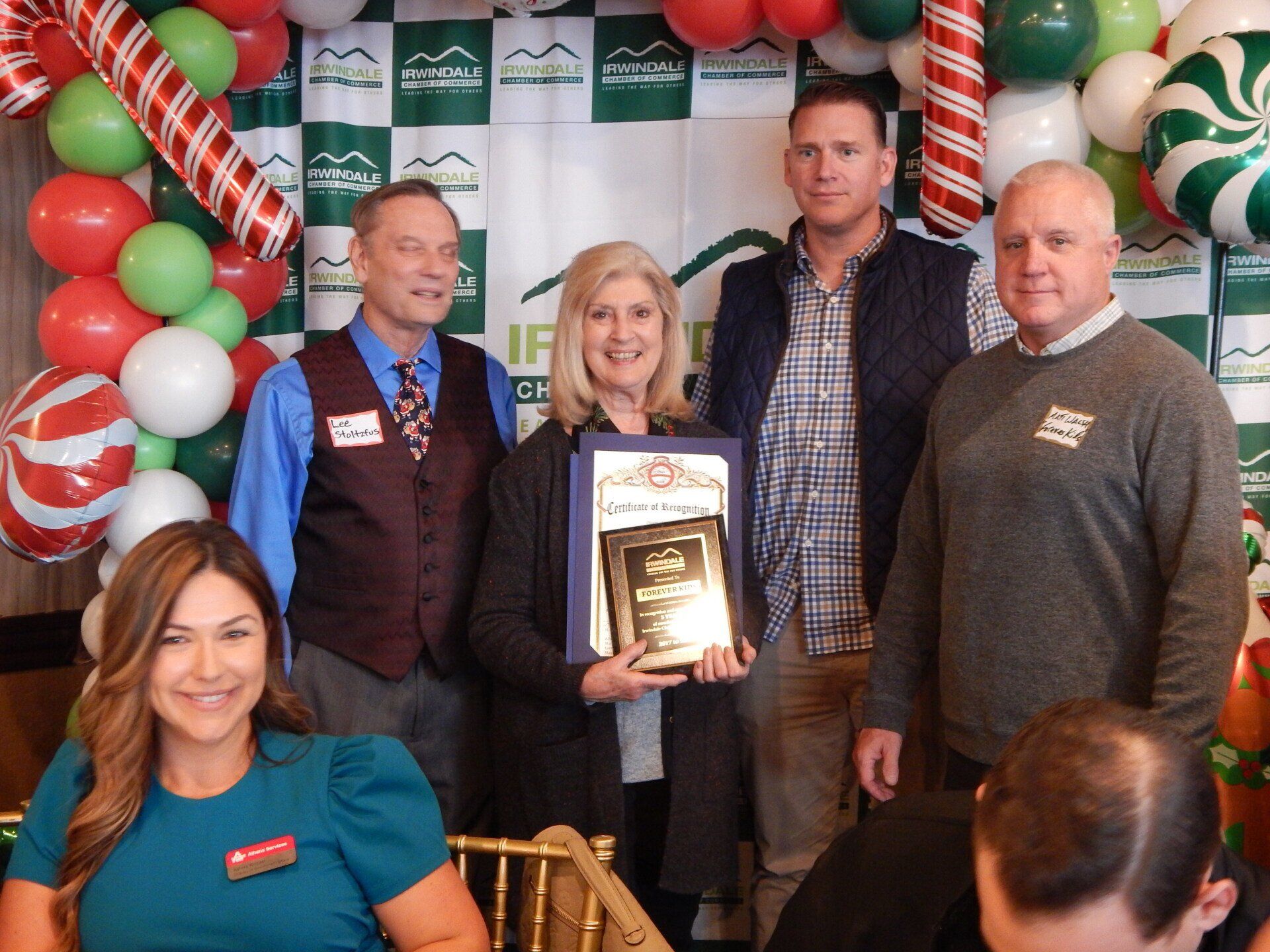 A group of people posing for a picture with balloons in the background