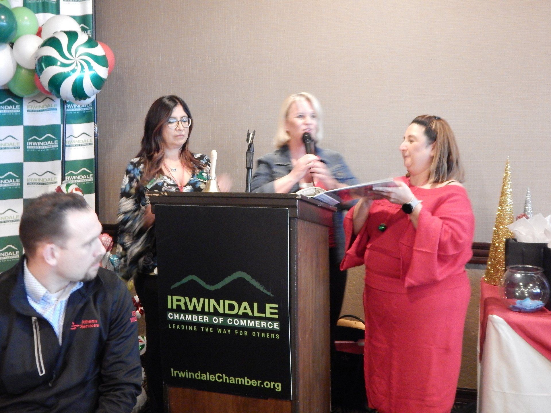 A group of people standing around a podium that says irwindale