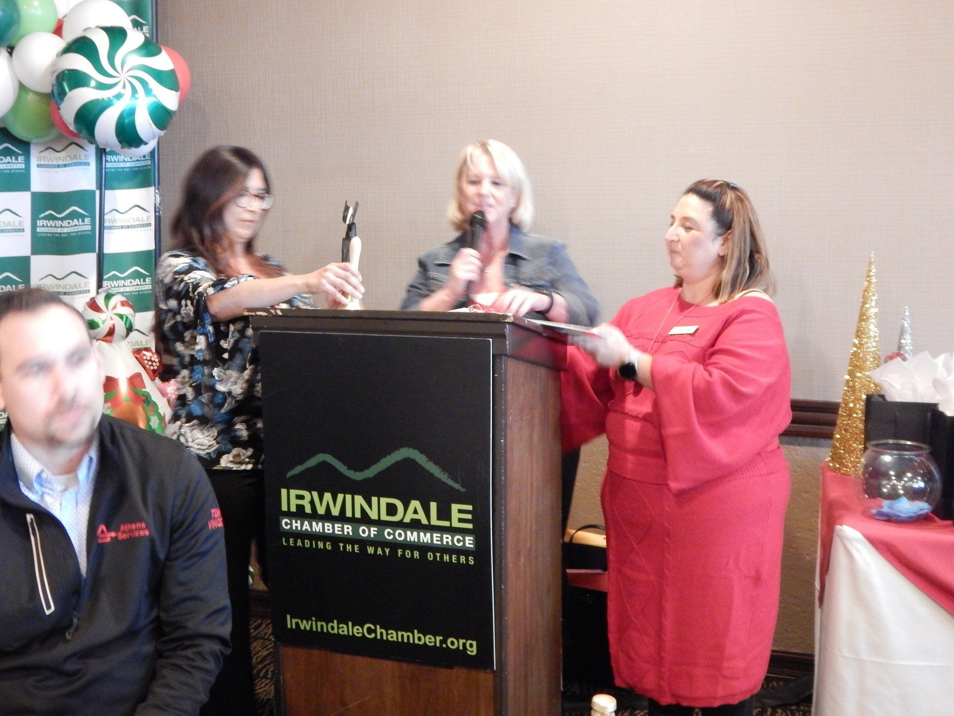 A group of people standing around a podium that says irwindale