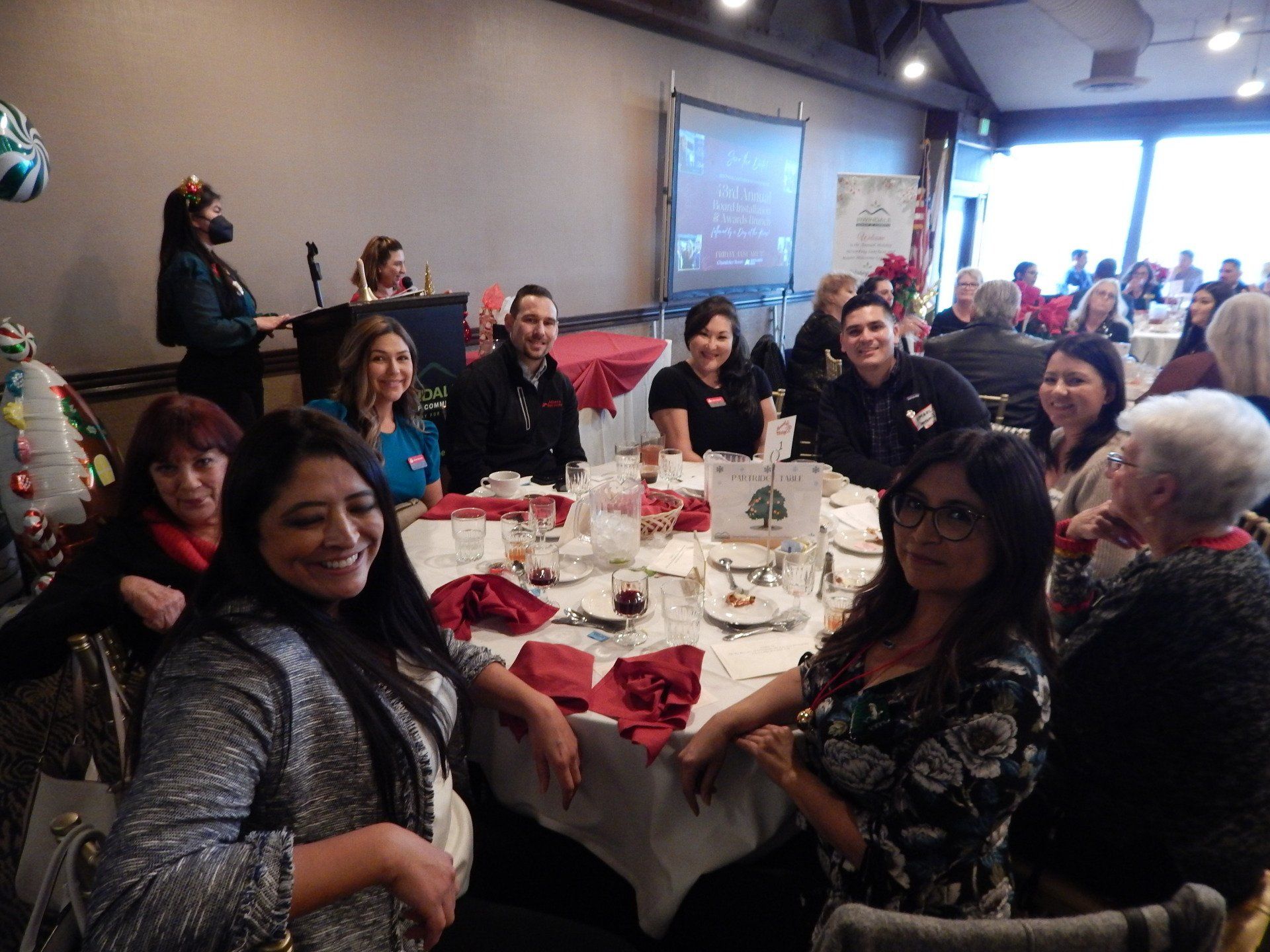 A group of people are sitting at tables in a room.