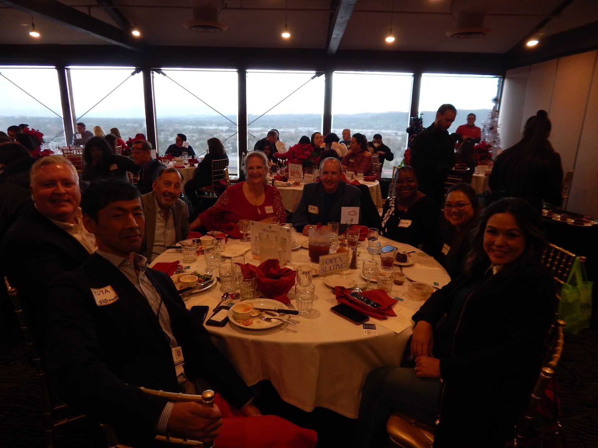 A group of people are sitting at tables in a restaurant.