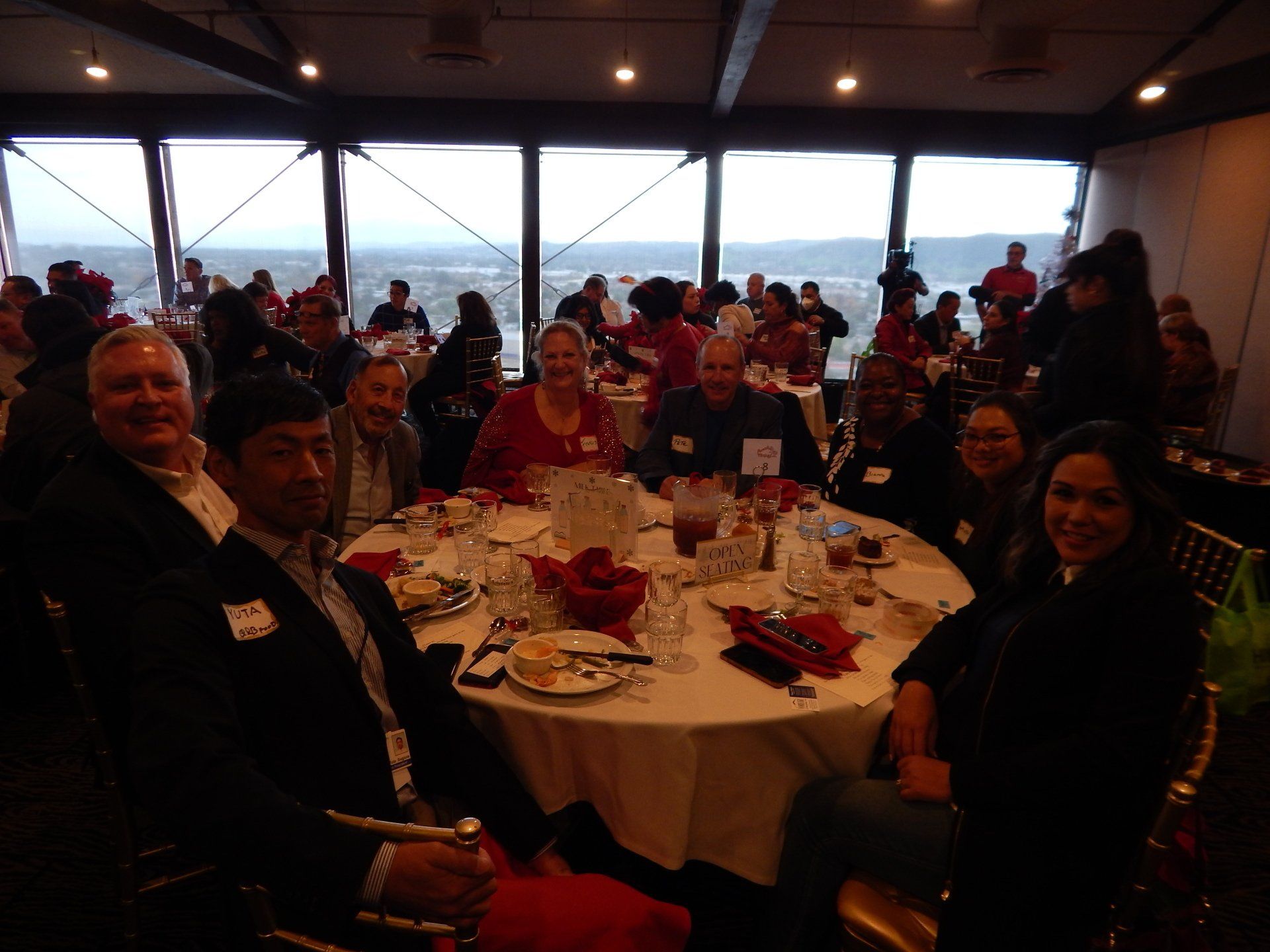 A group of people are sitting at tables in a restaurant.