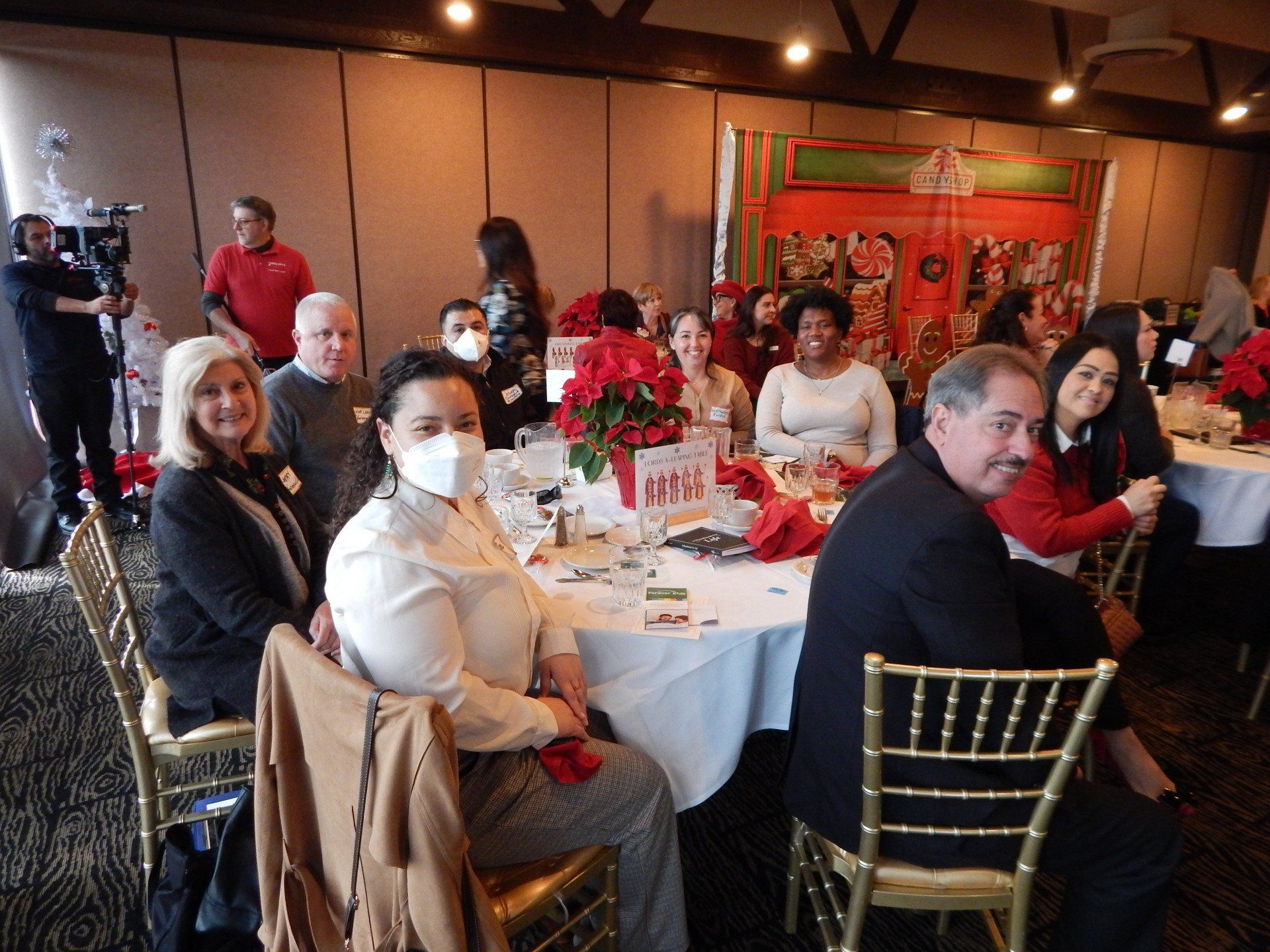 A group of people are sitting at tables in a room.