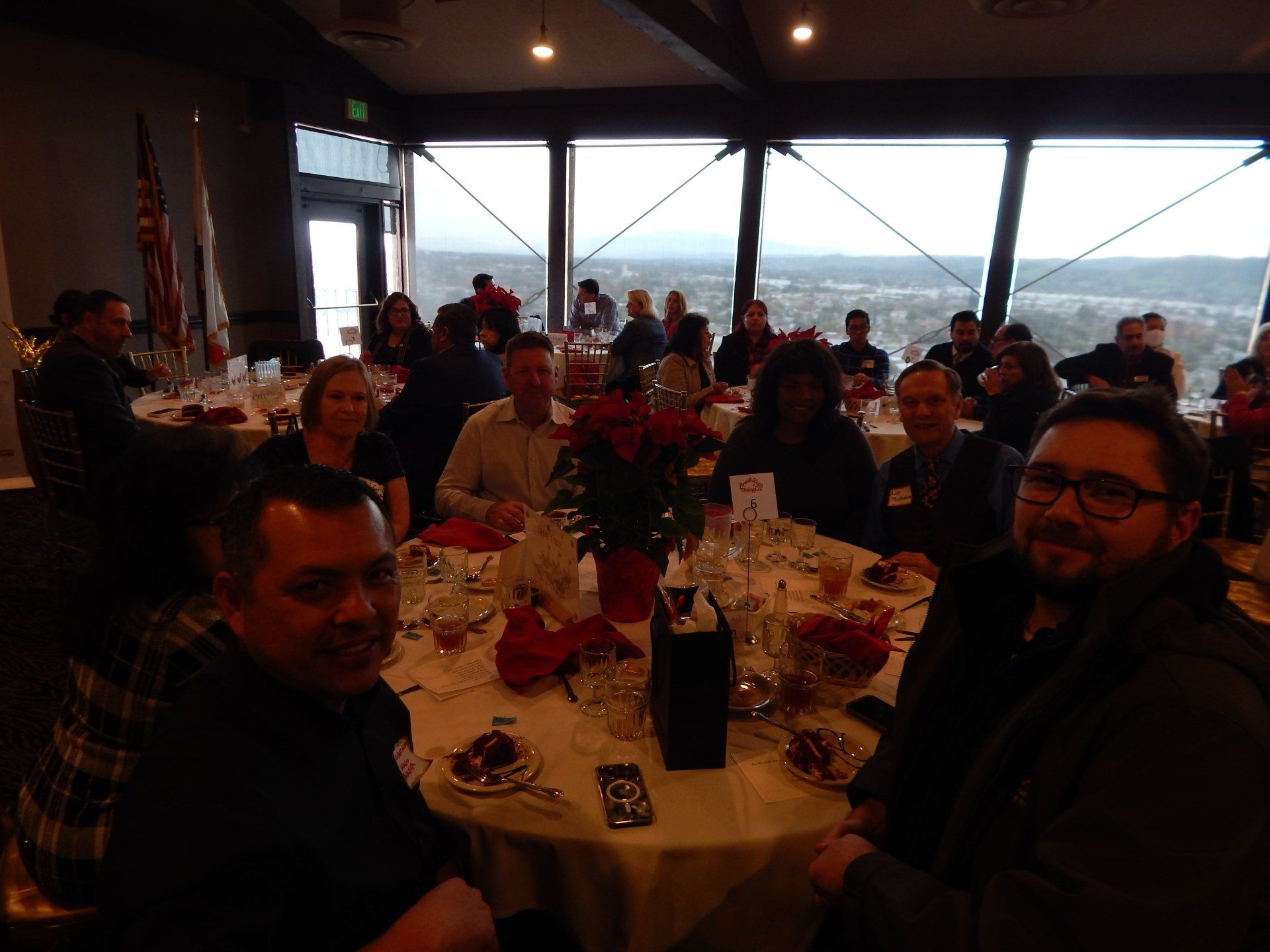 A group of people are sitting at tables in a restaurant.
