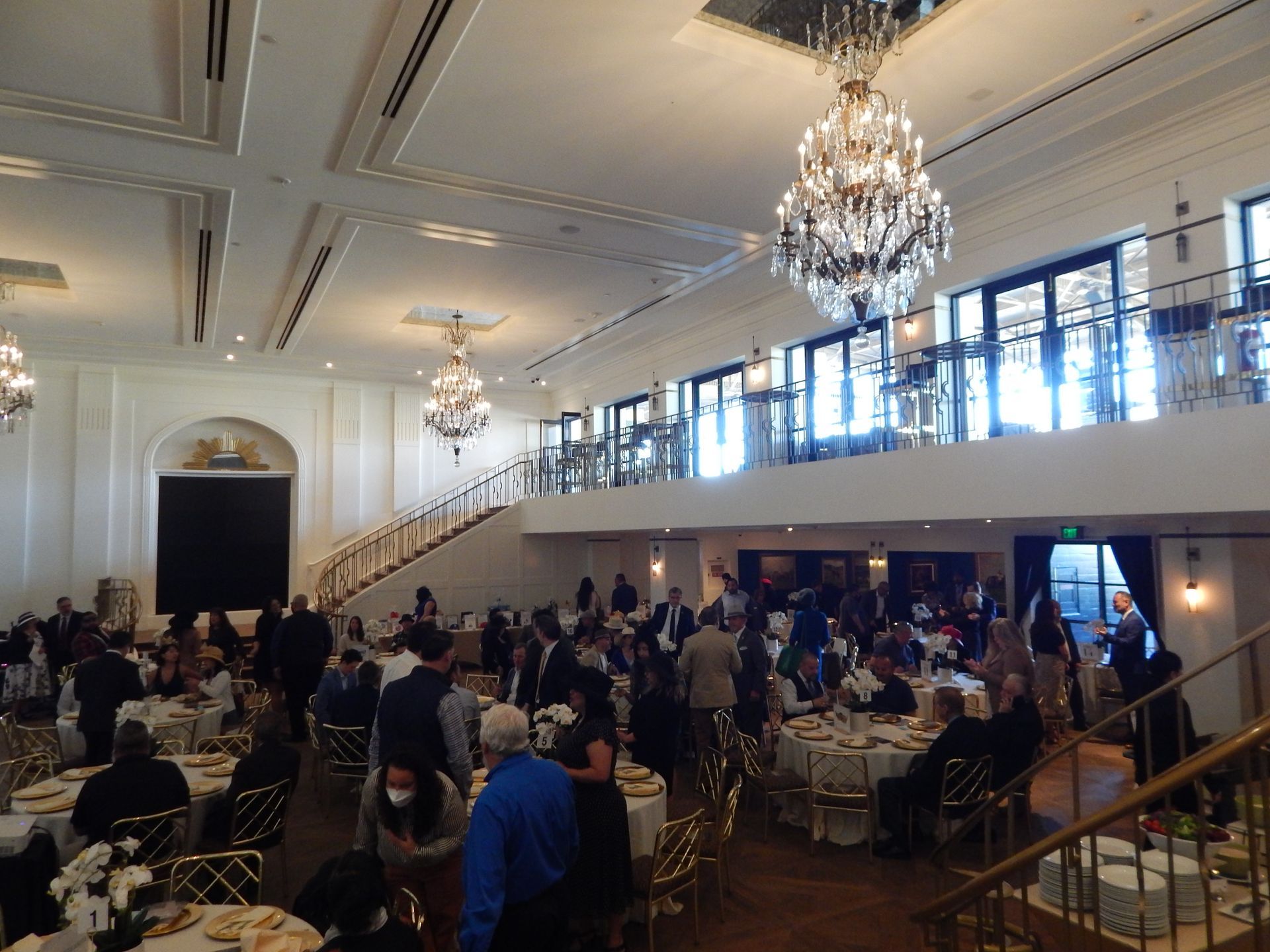 A large room with a lot of people sitting at tables