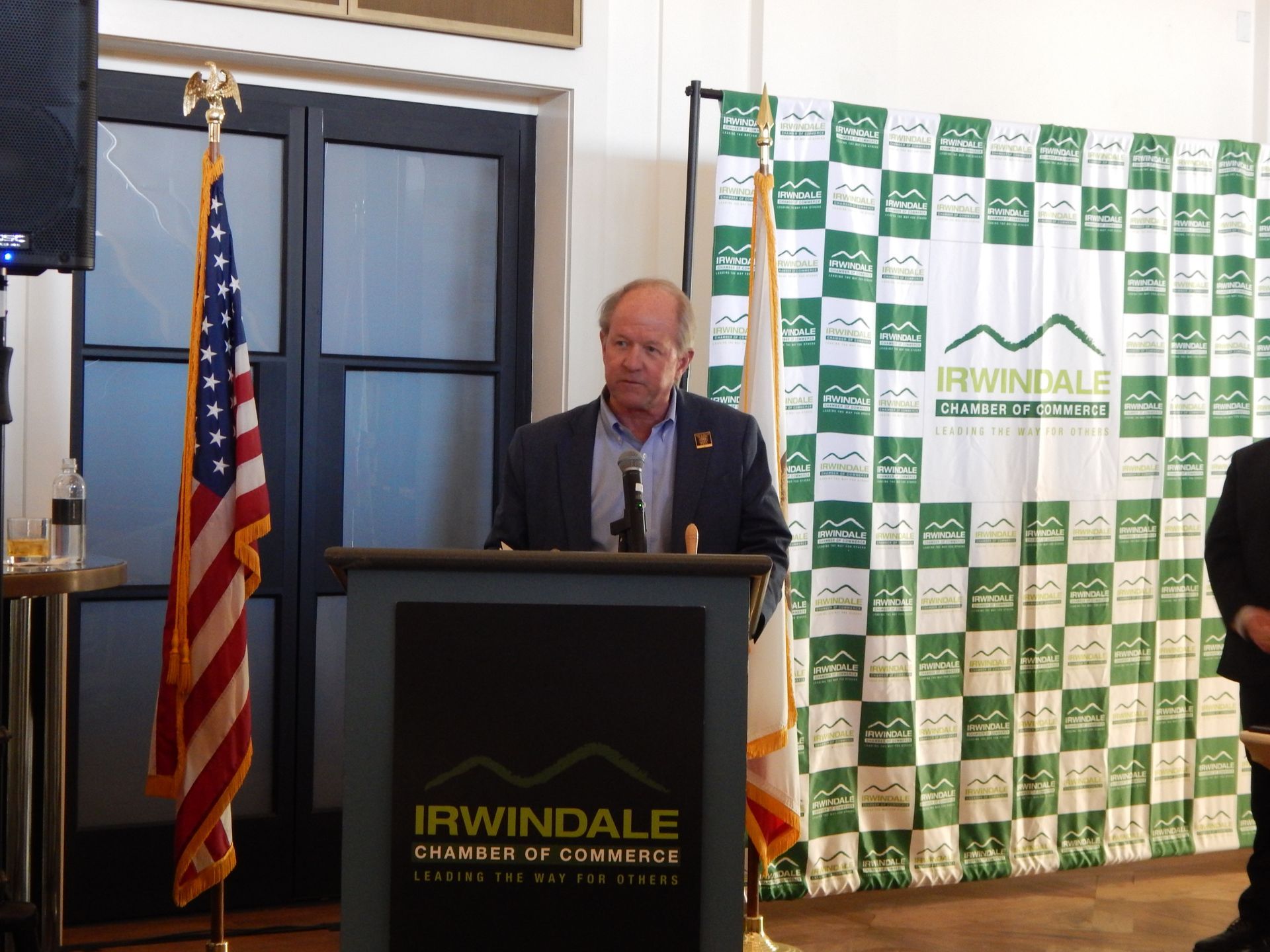 A man stands at a podium that says irwindale on it