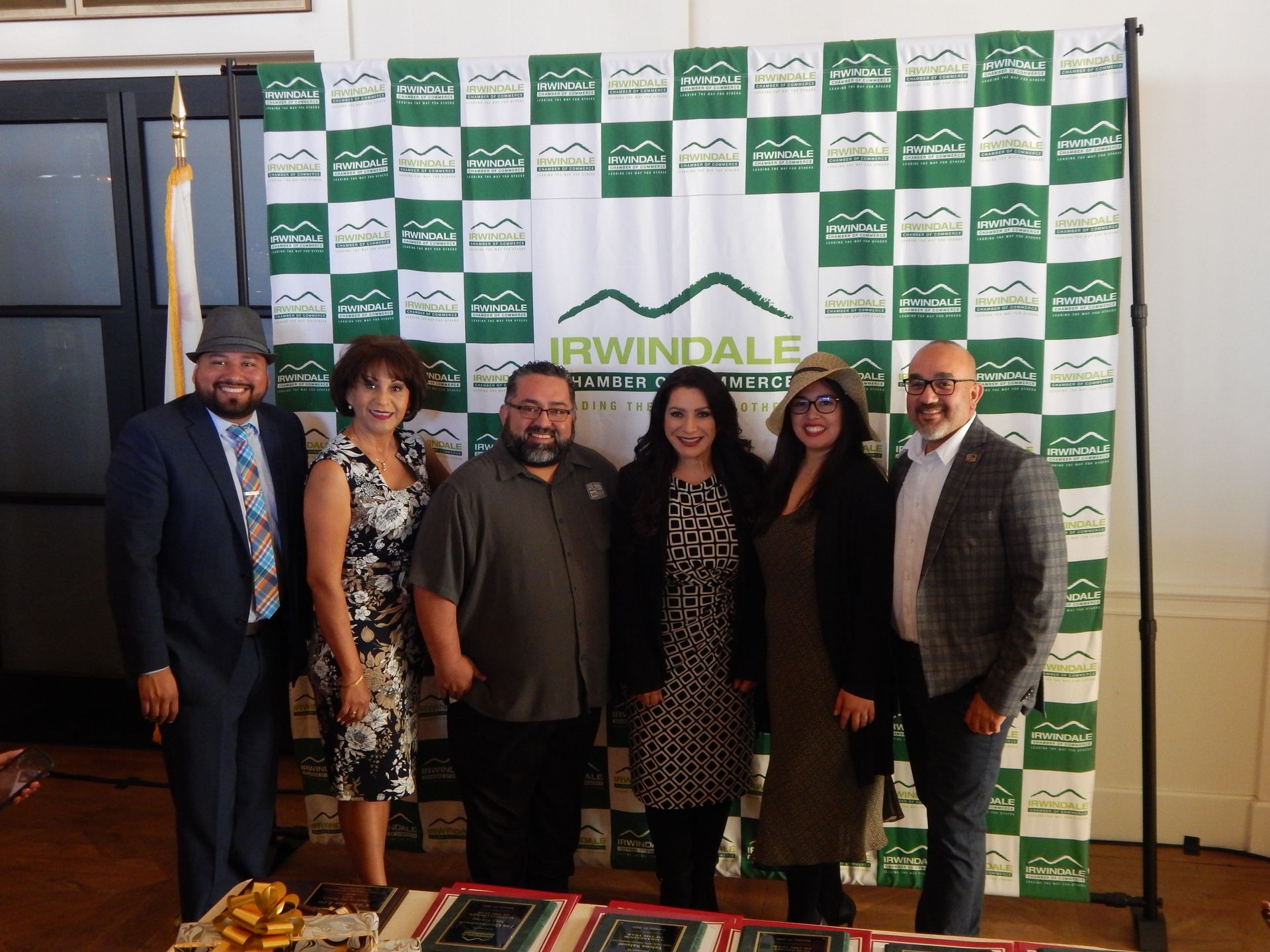 A group of people standing in front of a banner that says irwindale