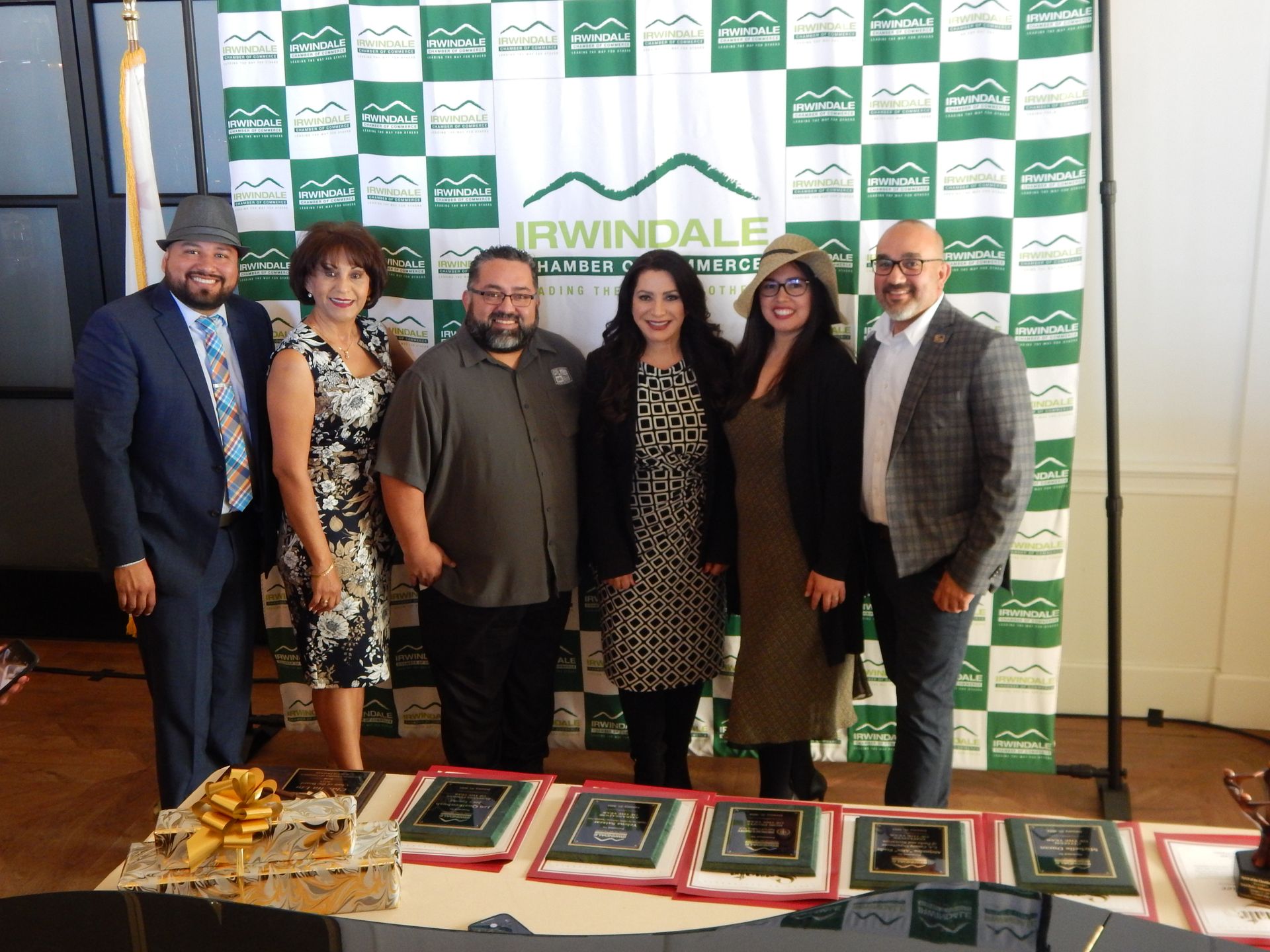 A group of people are posing for a picture in front of a banner that says erwindale