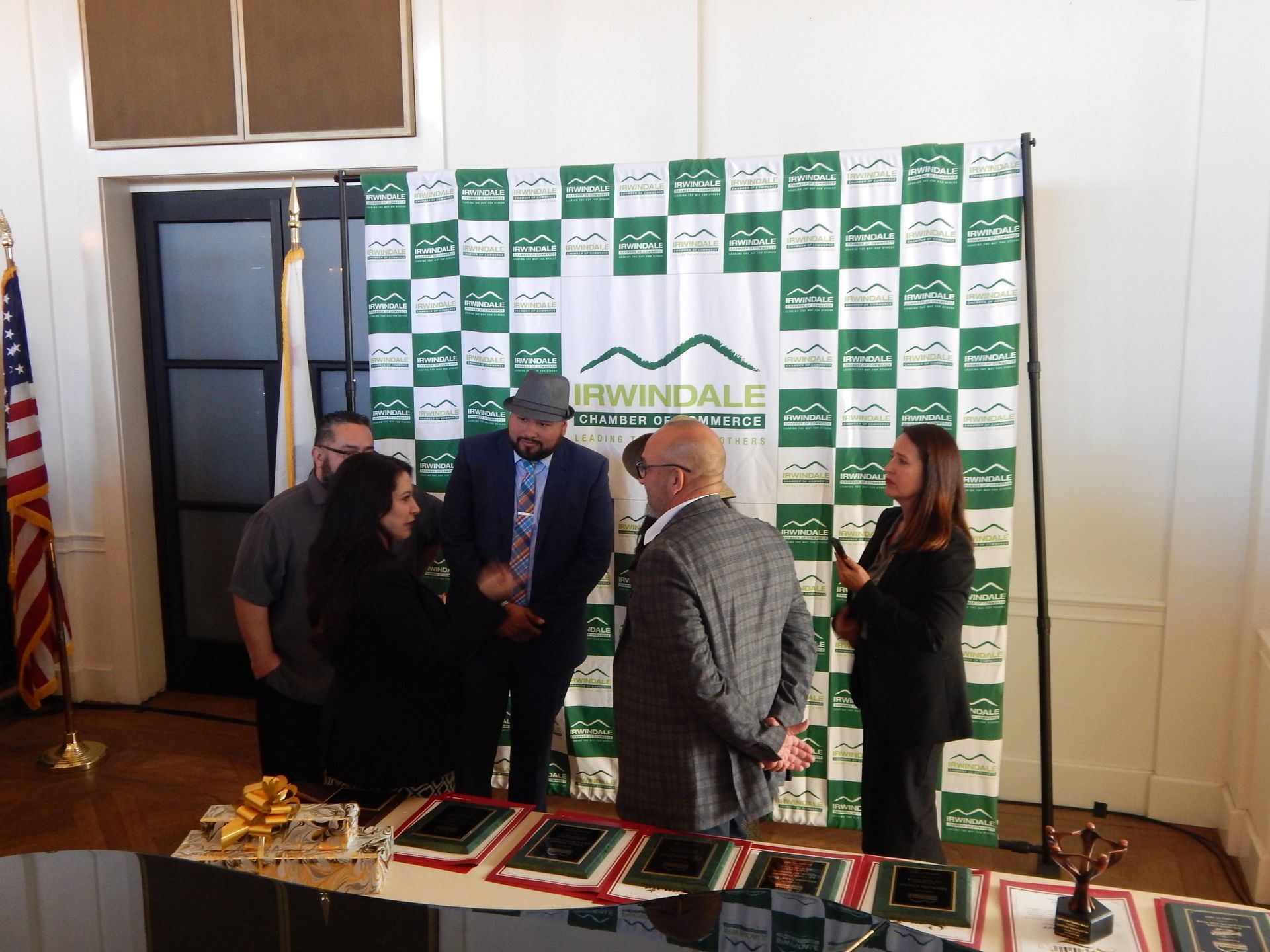 A group of people standing in front of a banner that says irmindale