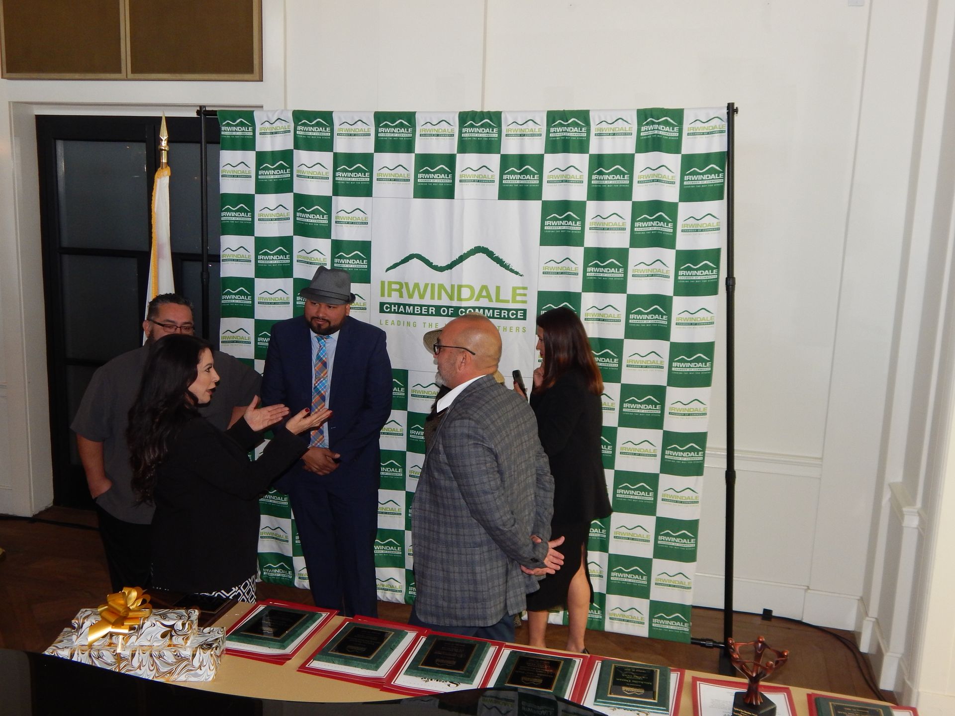 A group of people standing in front of a sign that says irwindale