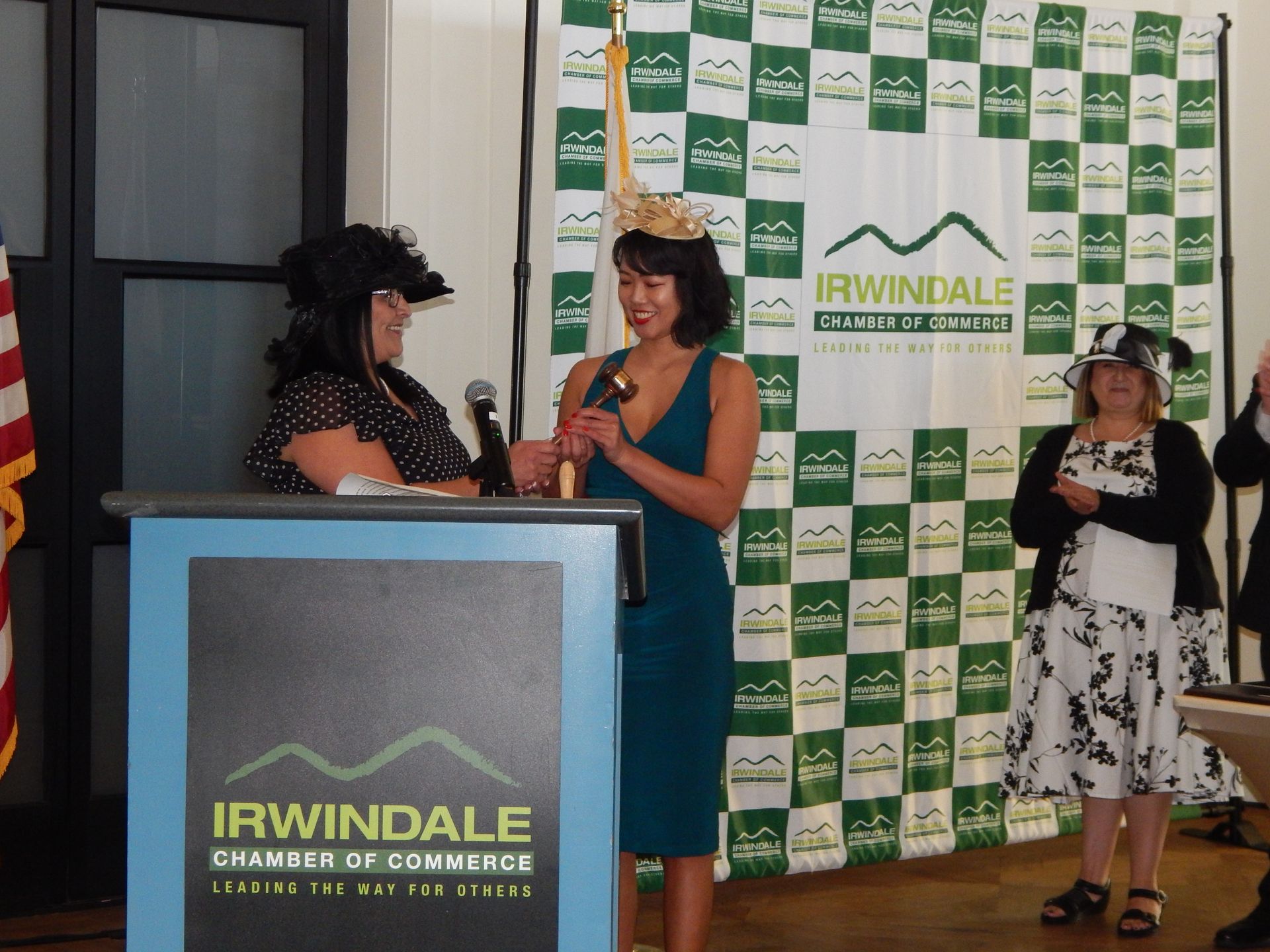 A woman stands behind a podium that says irwindale chamber of commerce