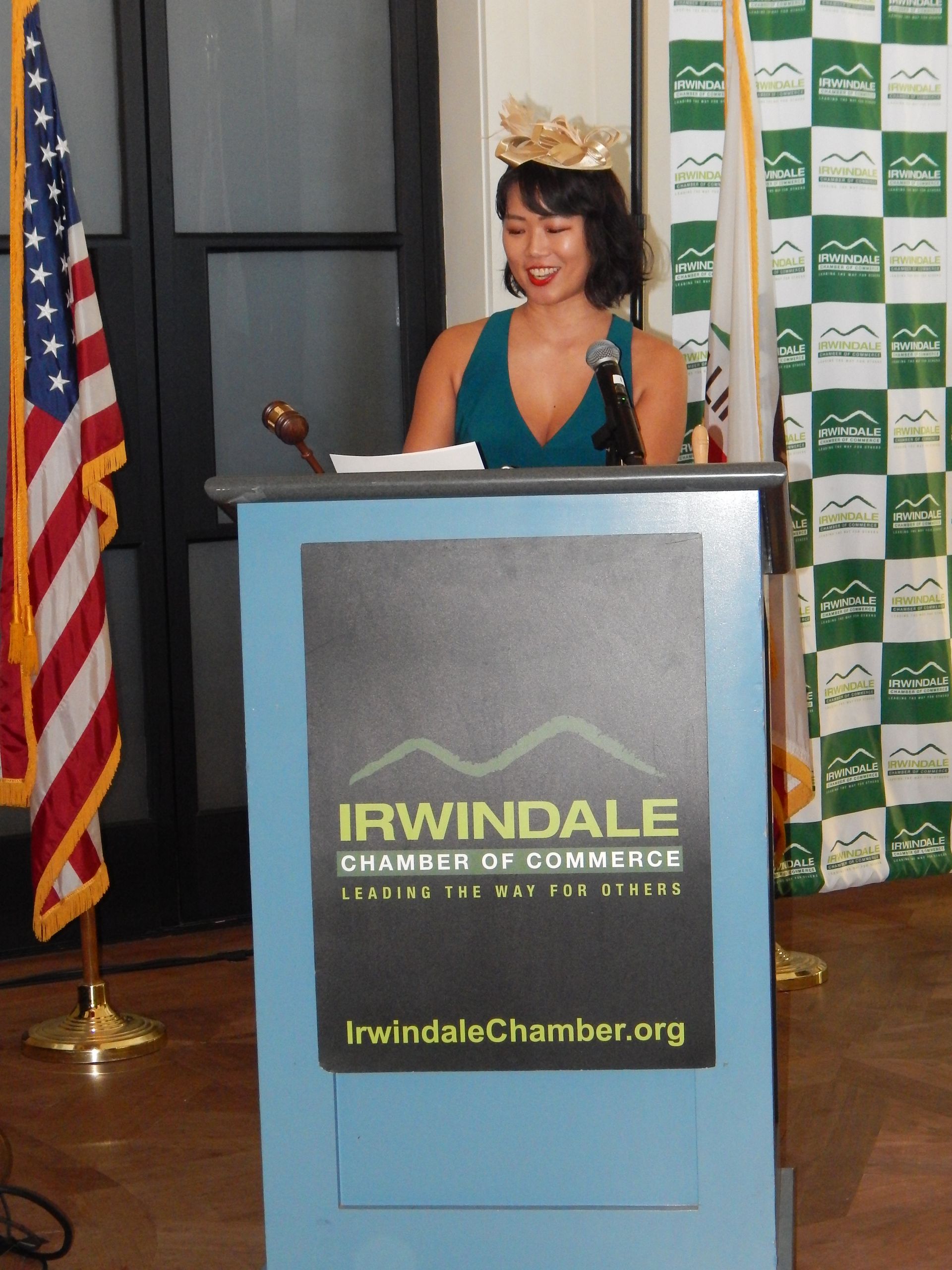 A woman stands at a podium that says irwindale on it