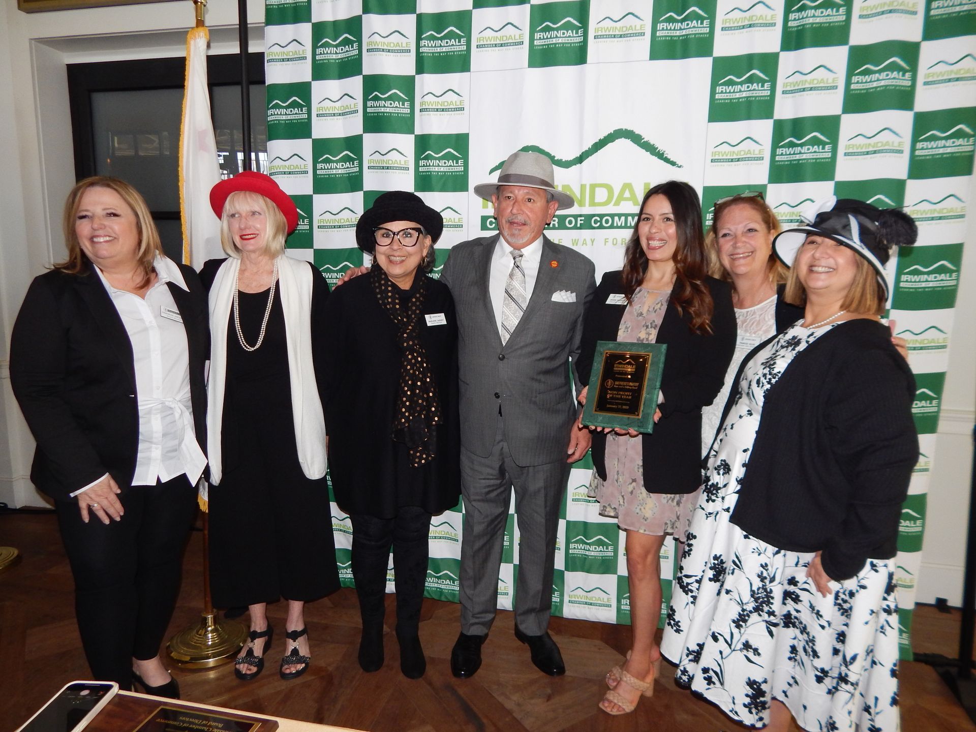 A group of people standing in front of a wall that says ida