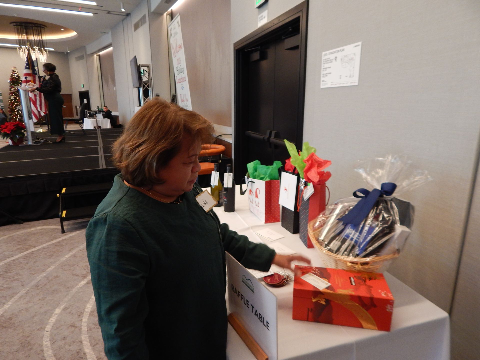 A woman is standing in front of a table with a basket on it.