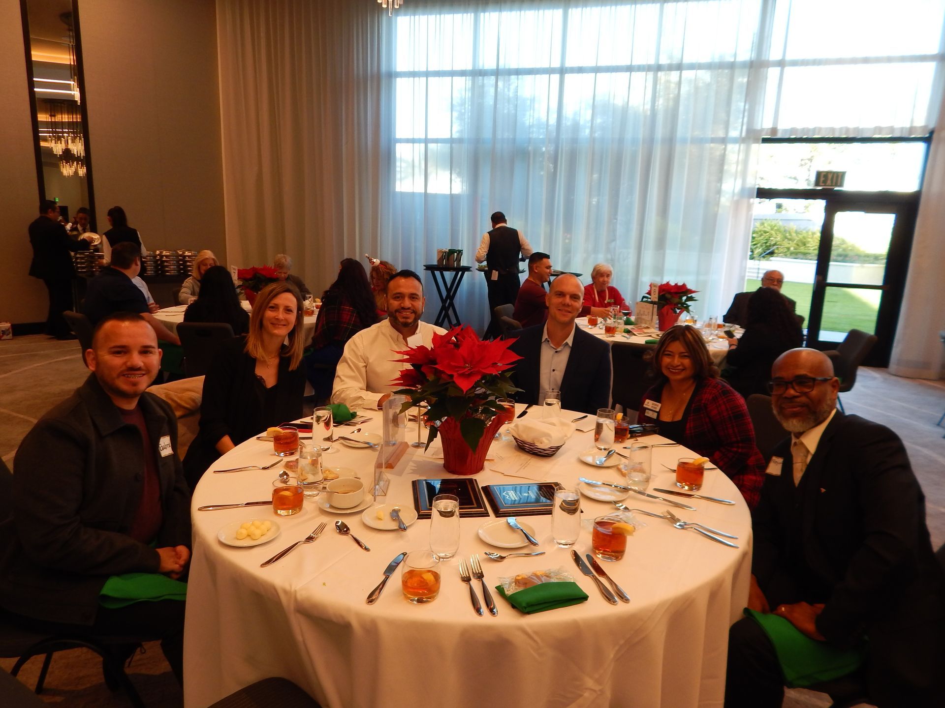 A group of people are sitting at a table in a room.