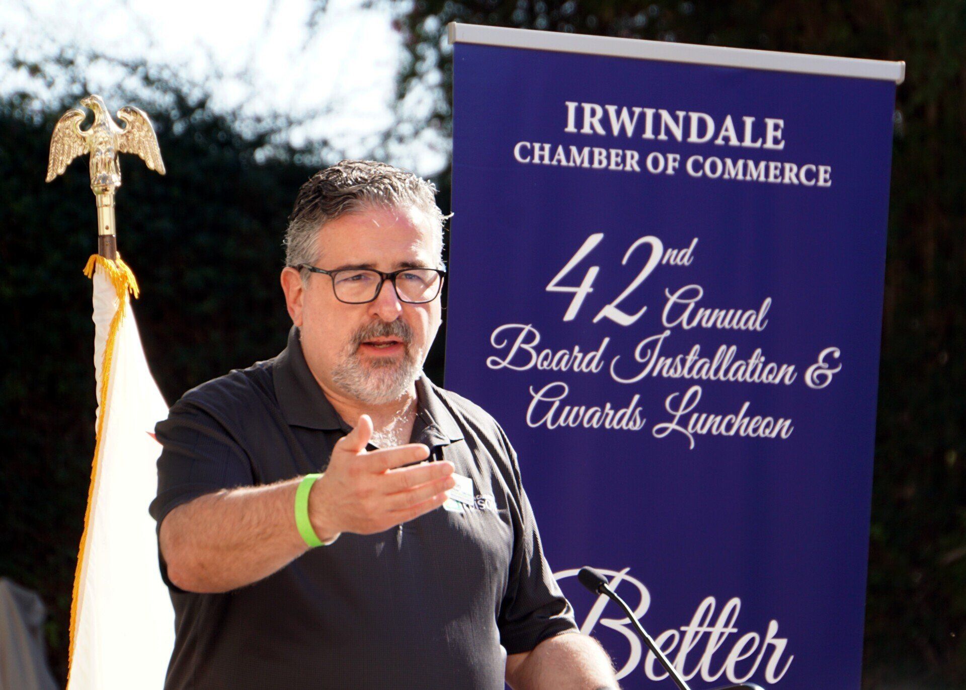 A man stands in front of a sign that says irwindale chamber of commerce