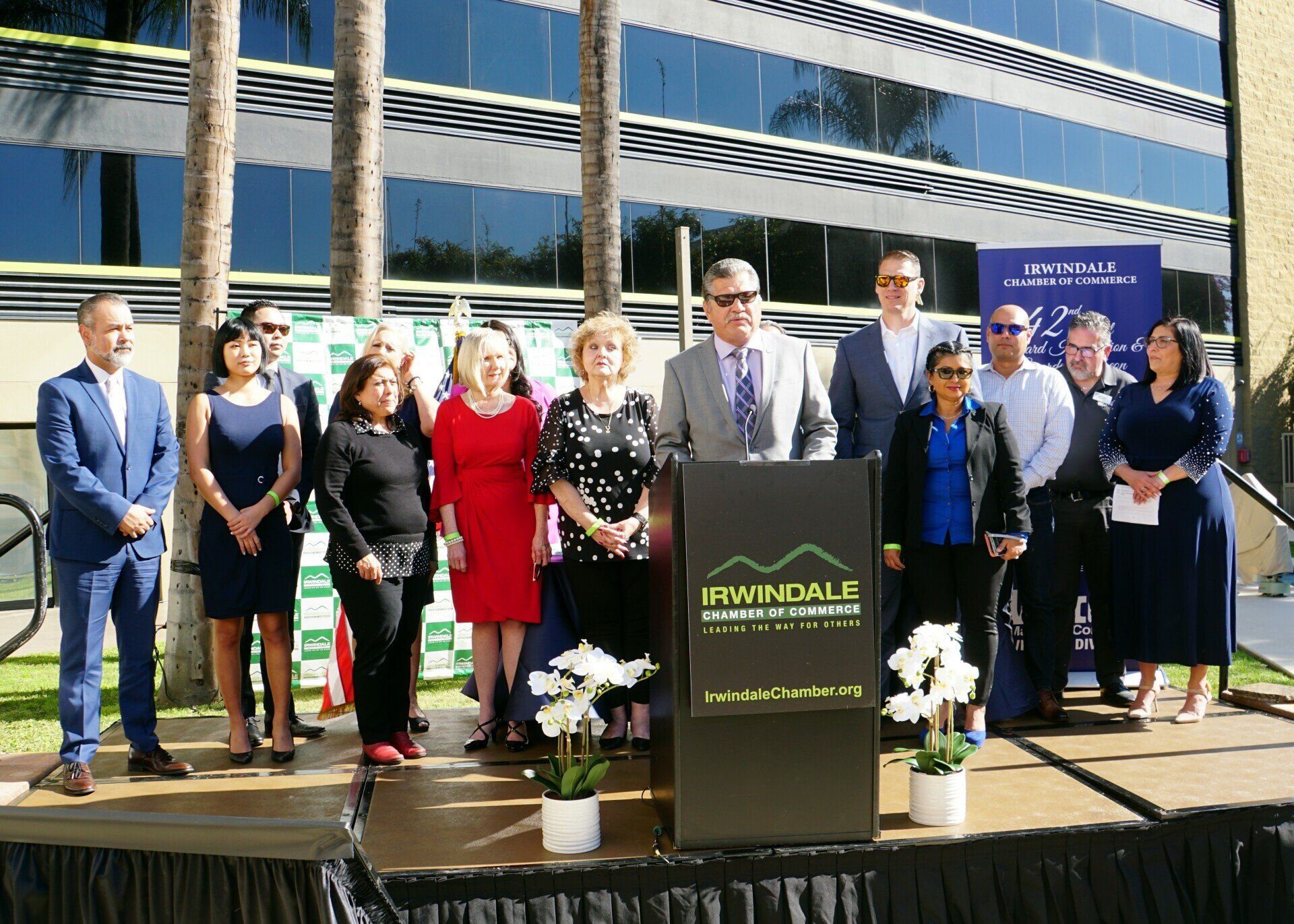 A group of people standing around a podium that says mathall