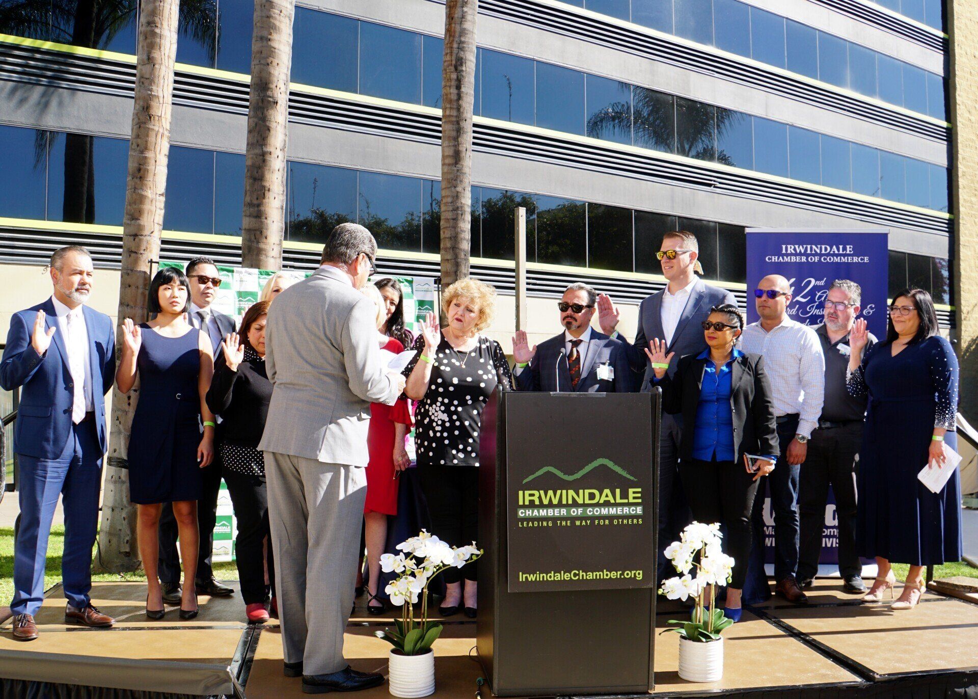 A group of people standing in front of a podium that says pmmdale