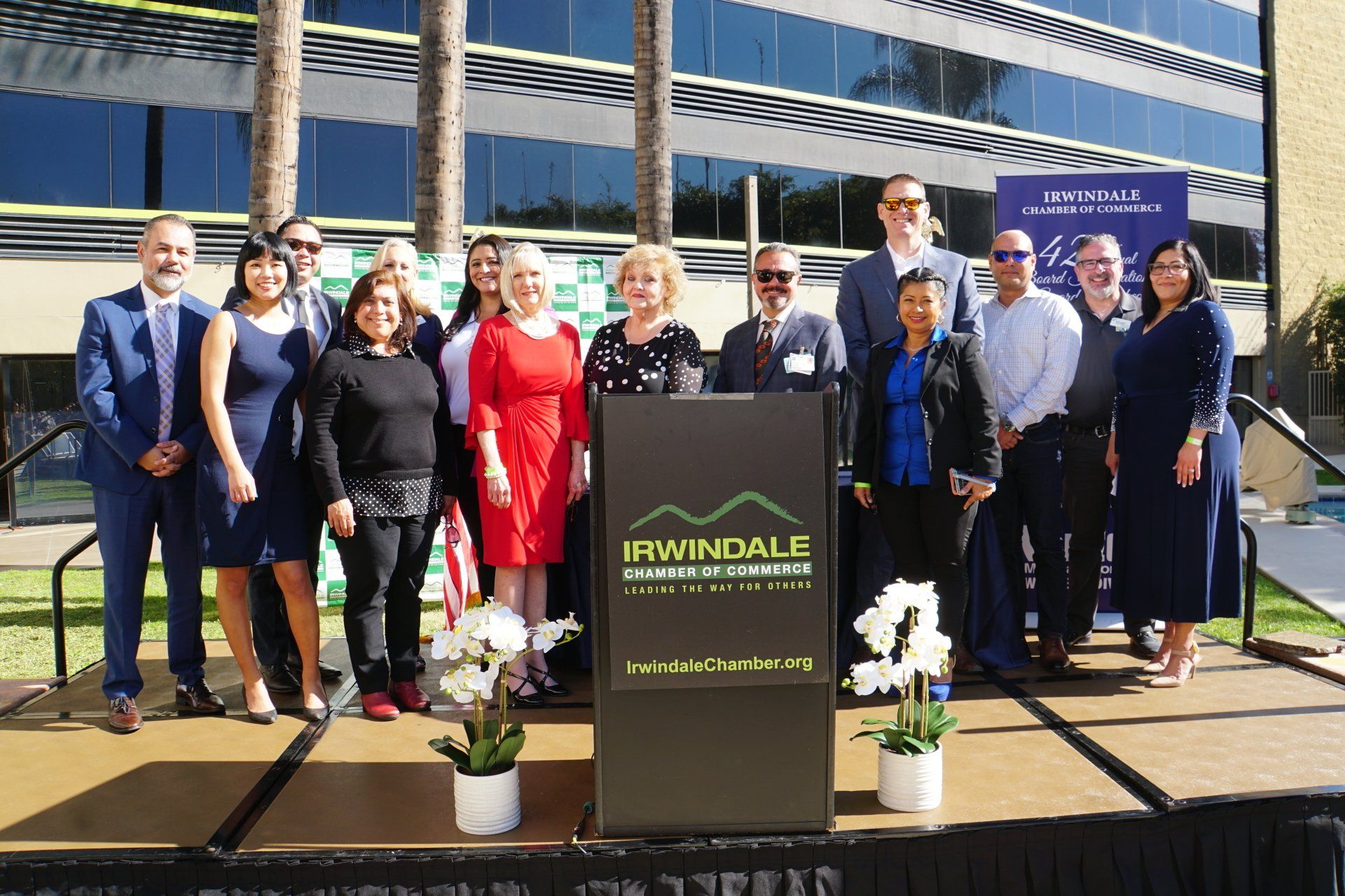 A group of people standing in front of a podium that says irwindale