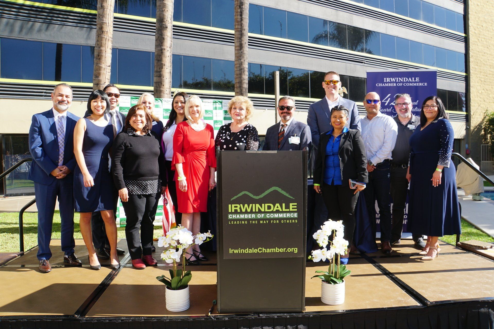 A group of people are posing for a picture in front of a podium.