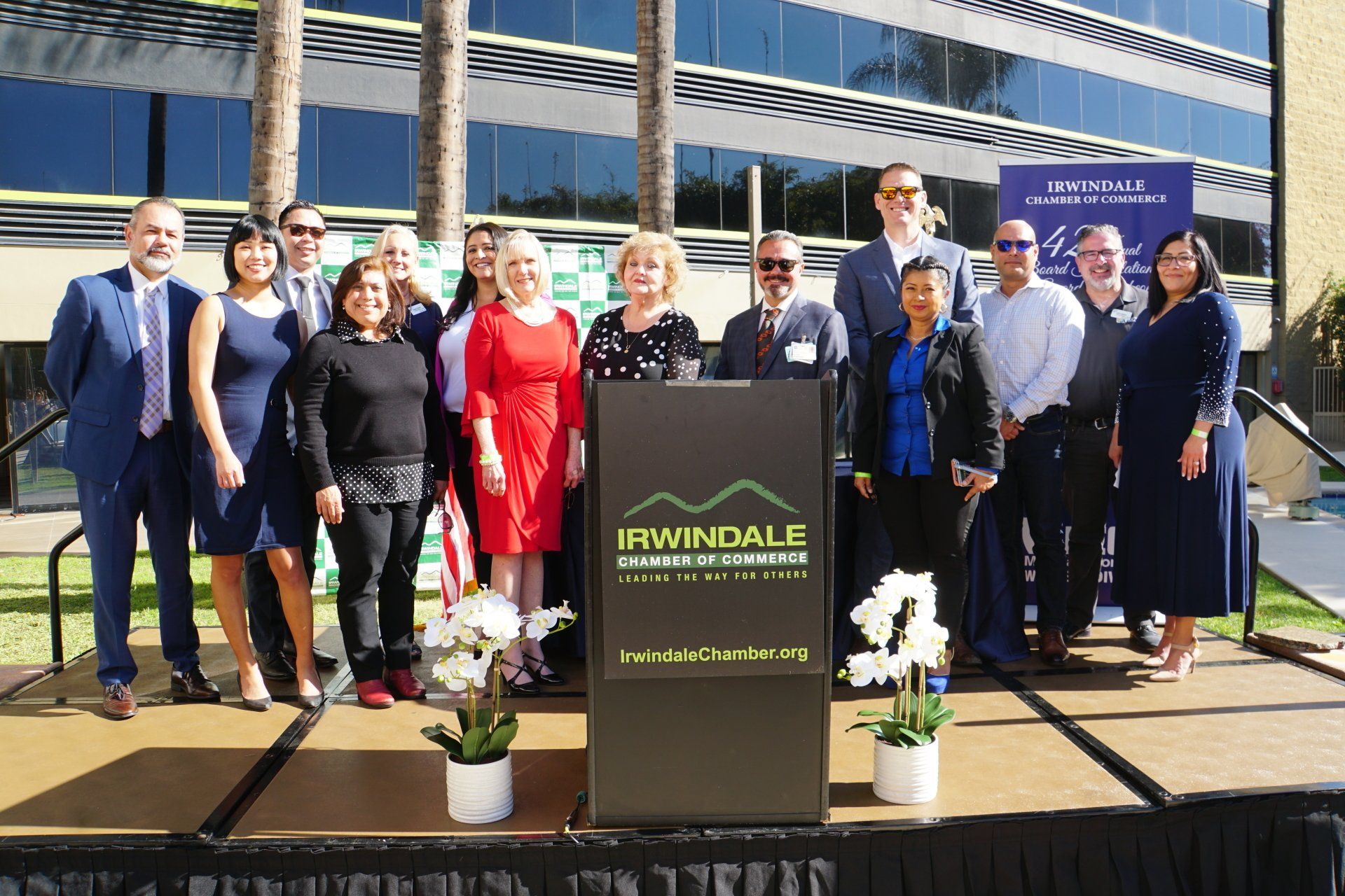 A group of people standing in front of a podium that says irwindale