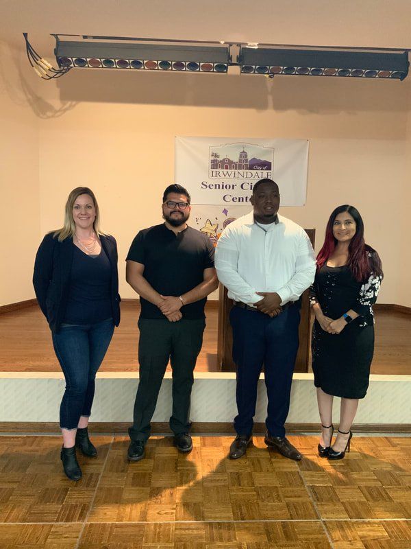 A group of people are standing next to each other on a stage.