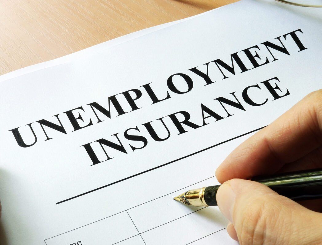 A person is filling out a form for unemployment insurance