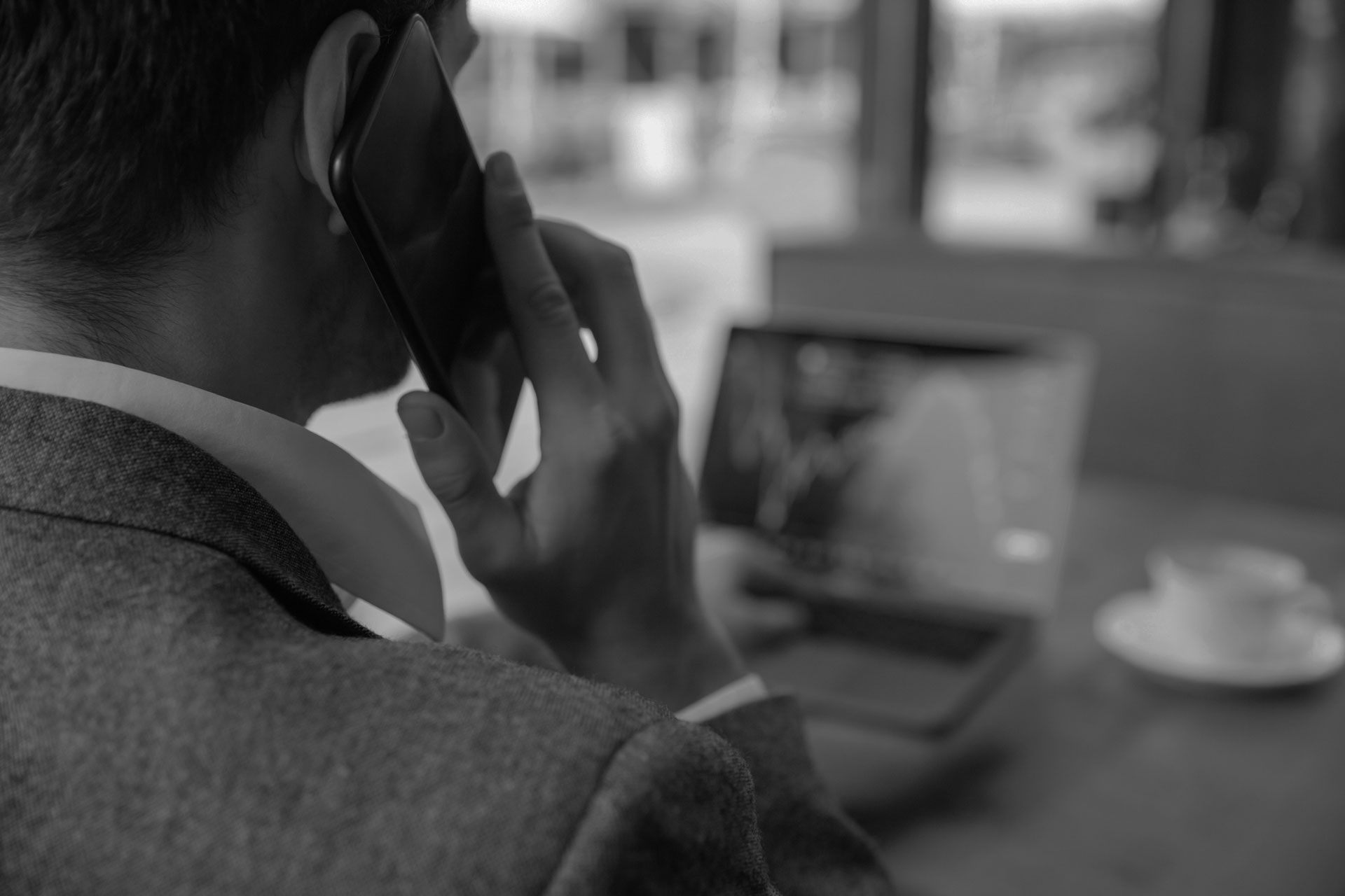 Laptop displaying "BRANDING" with colorful circles, hands on keyboard, coffee mug nearby.