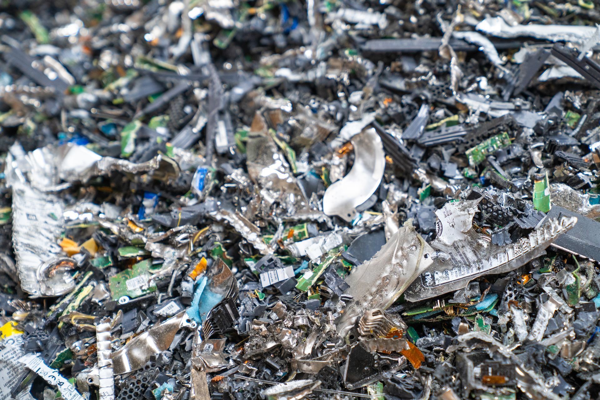 Pile of electronic waste, with circuit boards, metal, and plastic.