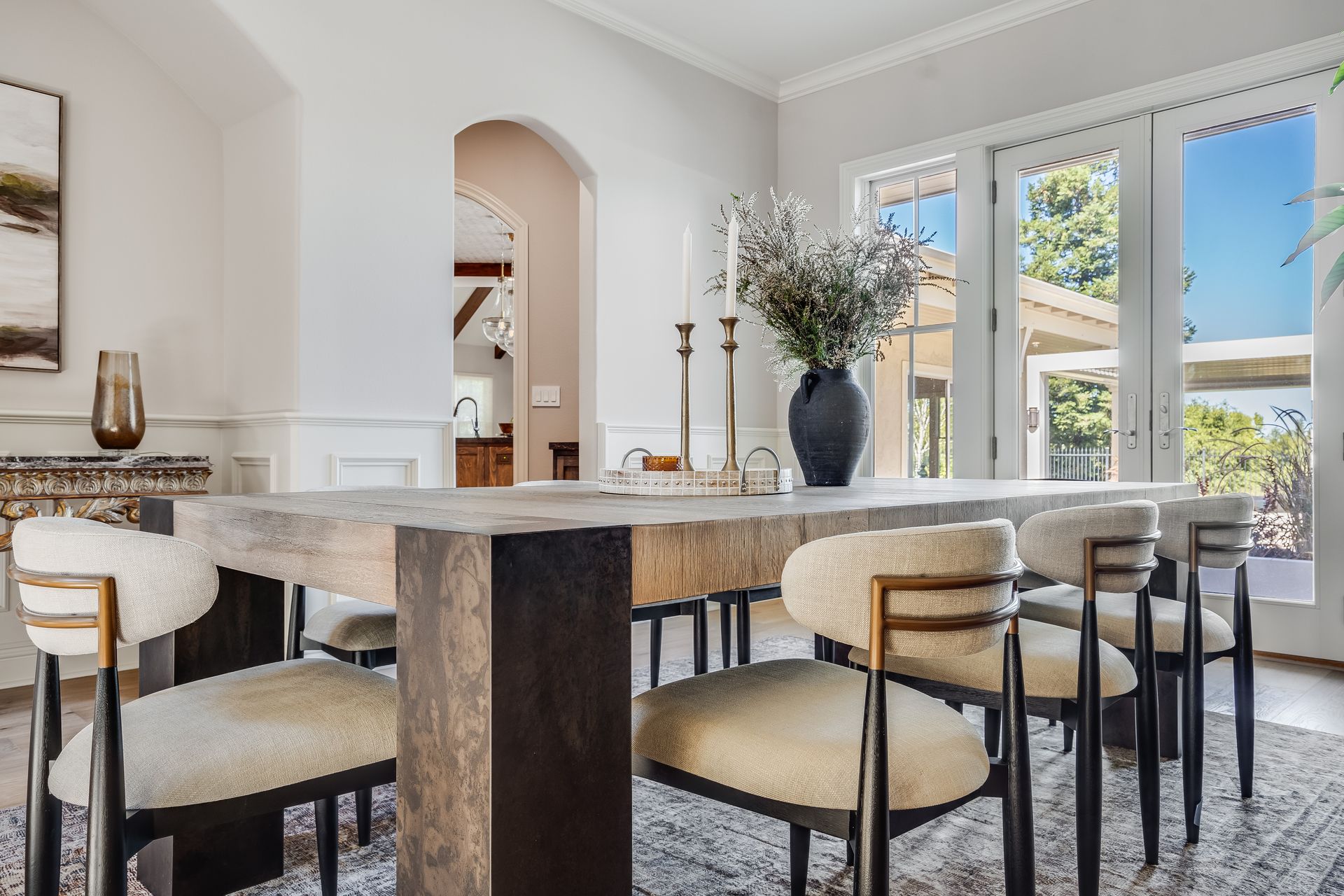 Dining room with a large wooden table and modern chairs.