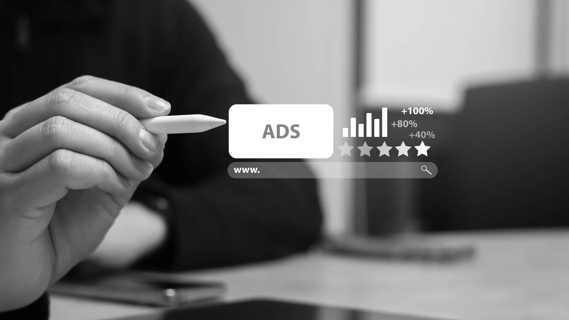 A person is holding a pen in front of a screen that says ads.