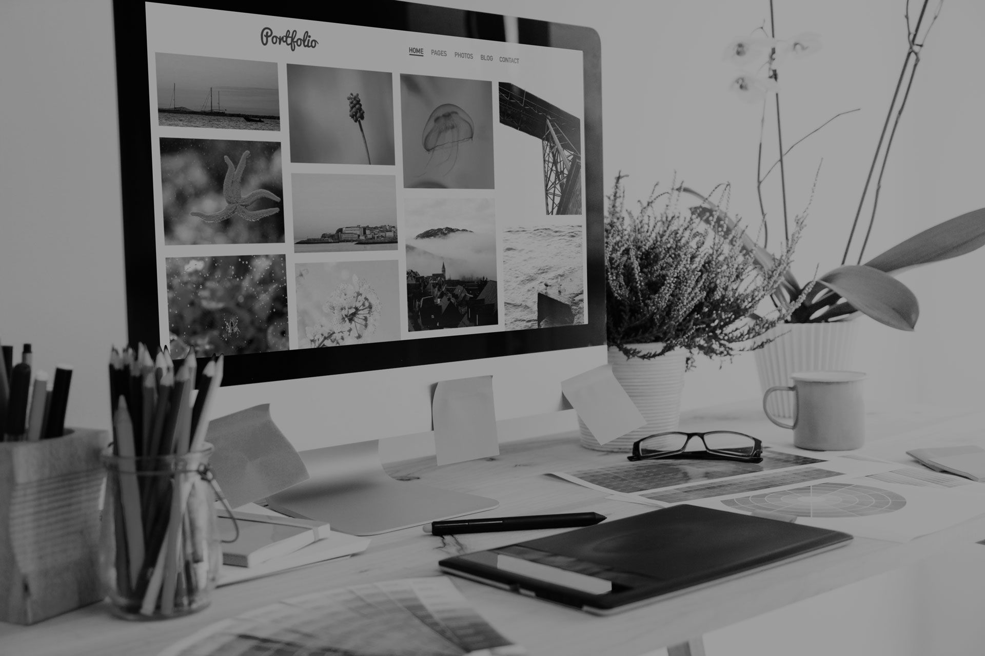A black and white photo of a computer on a desk.
