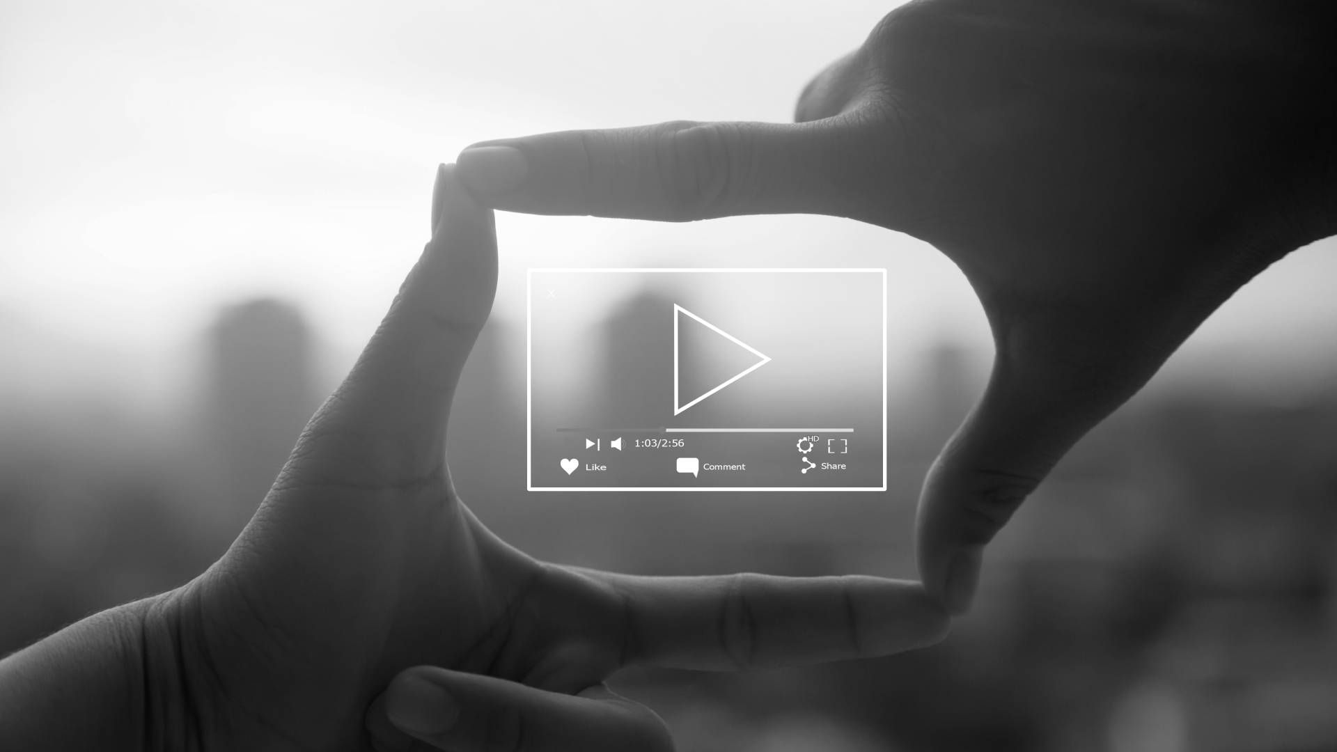 A person is making a frame with their hands around a video player.