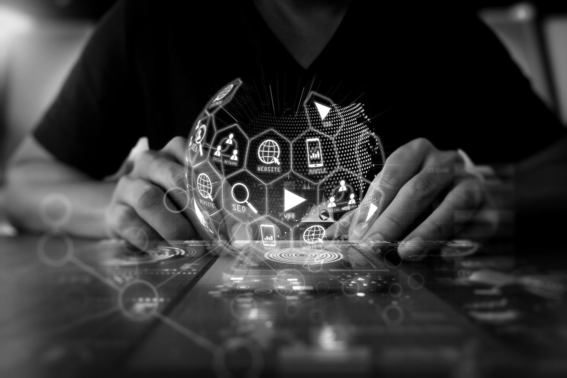 A person is holding a glowing globe with icons on it.