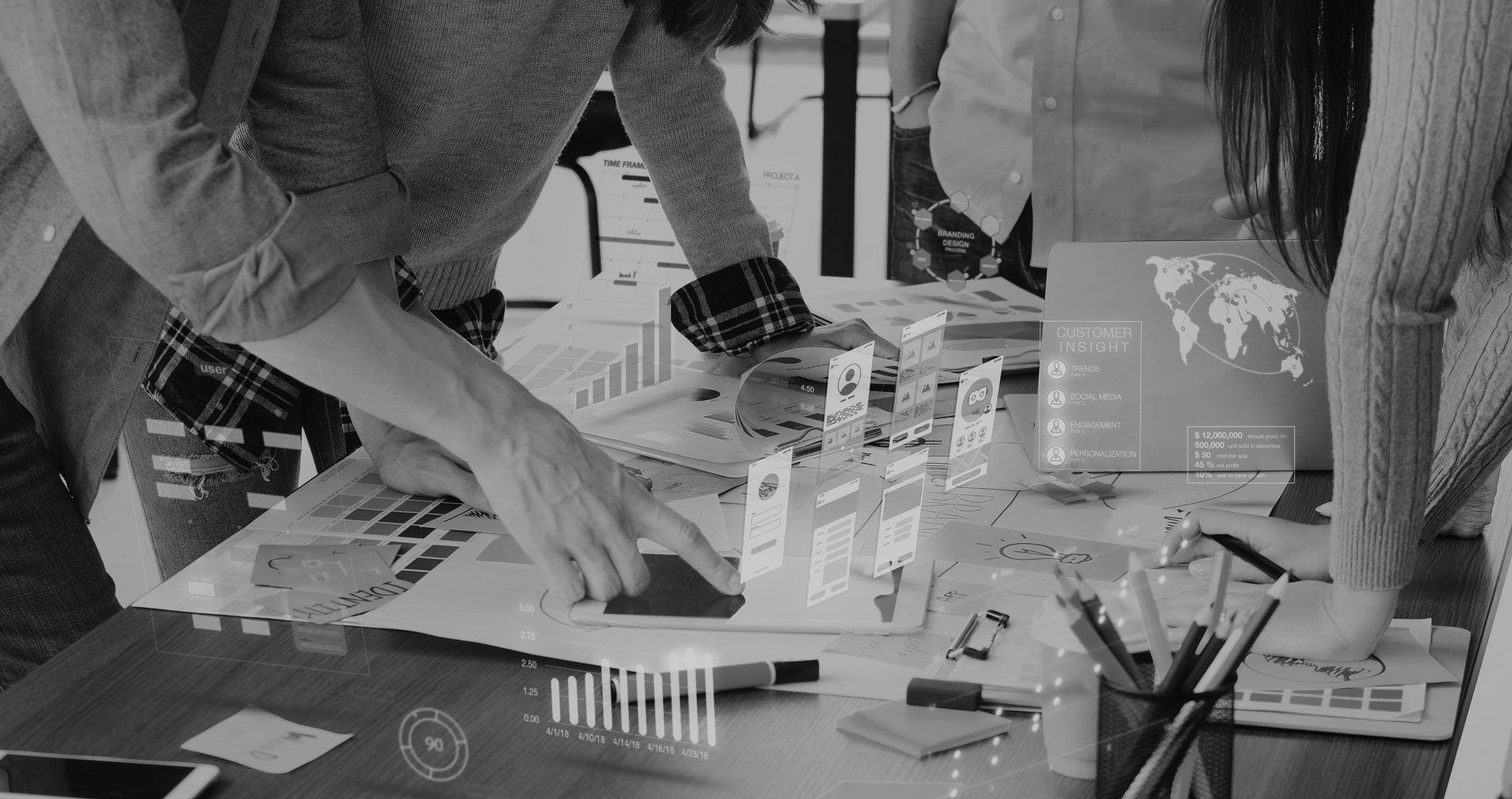 A group of people are sitting at a table working on a project.