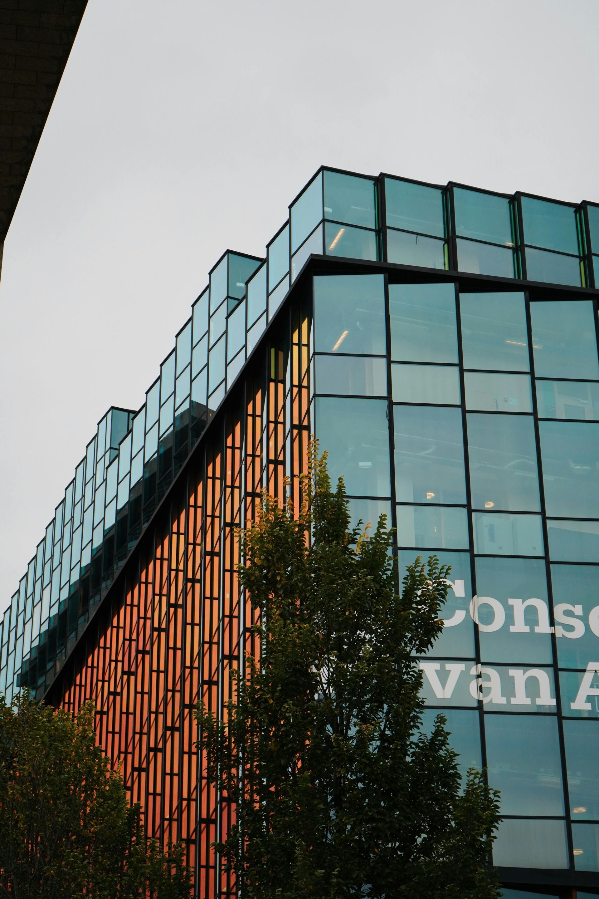 A building with a lot of windows has the word vancouver on it