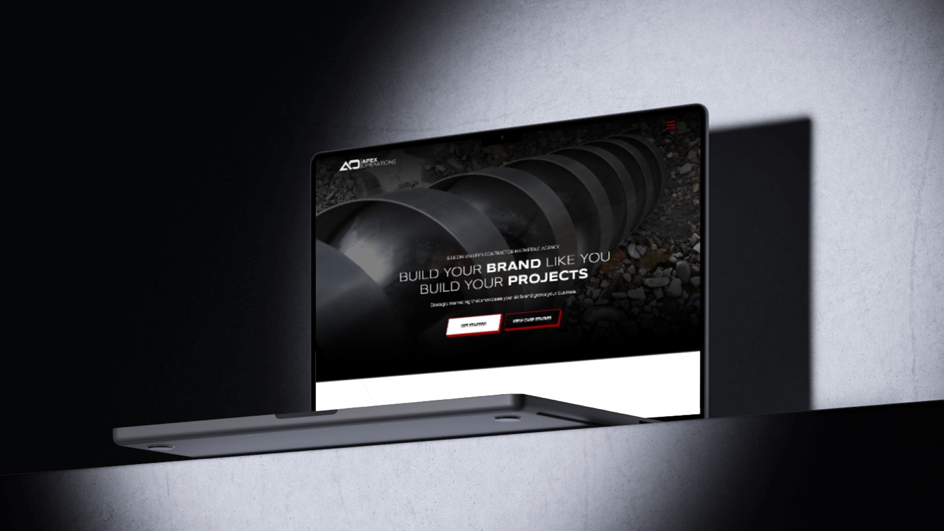 A laptop computer is sitting on a shelf in a dark room.