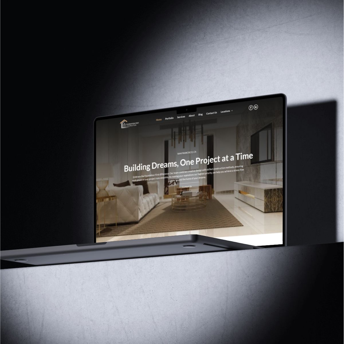 A laptop is open to a website that says building dreams one project at a time