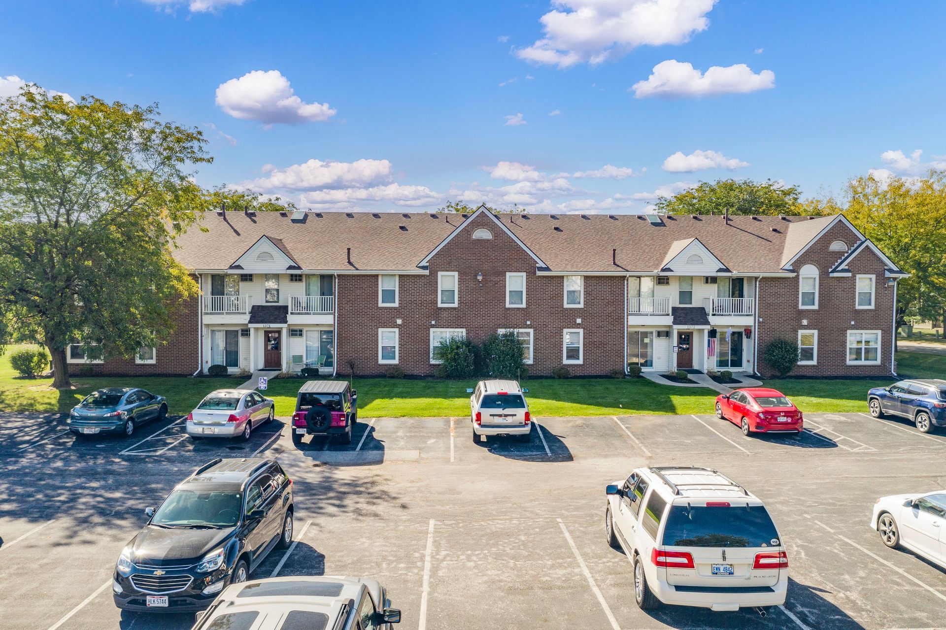 Photo of a two story building with a parking lot out front